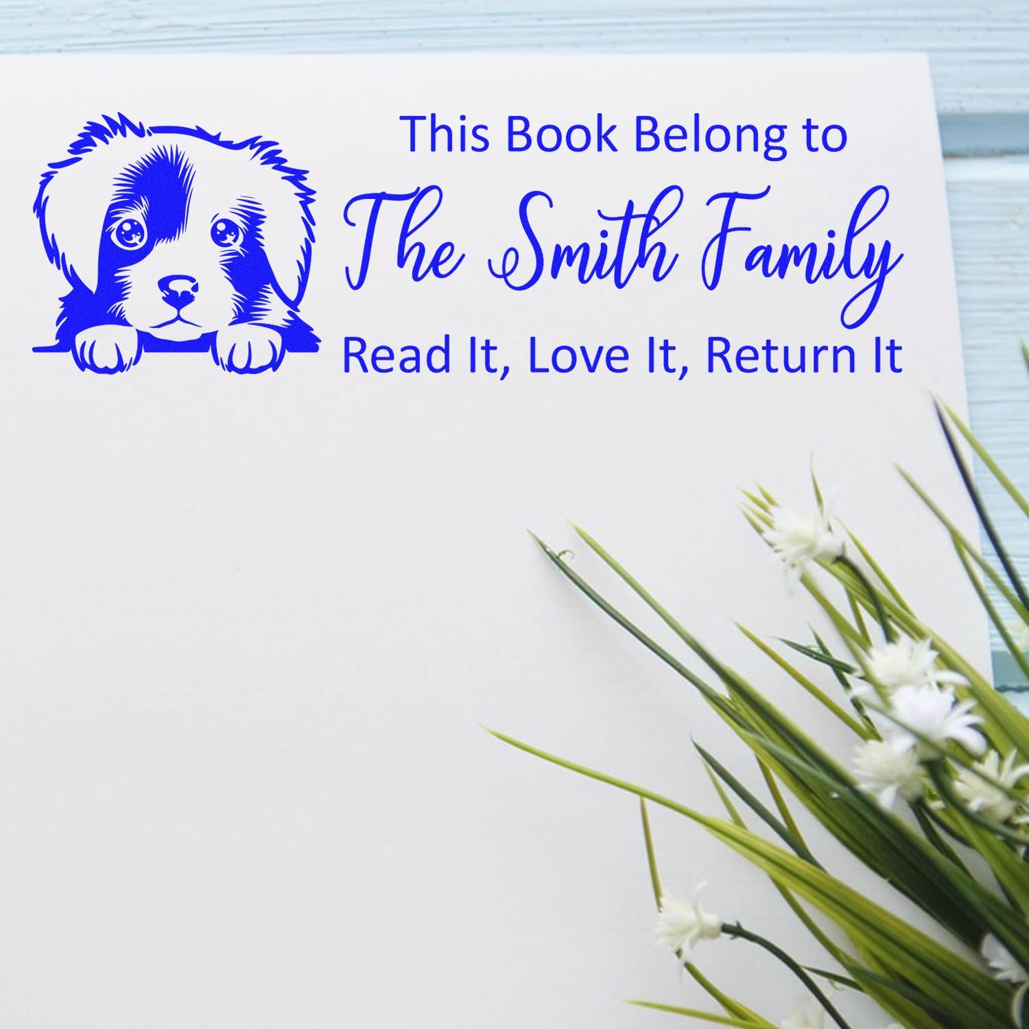 Personalized rubber book stamp with dog design for The Smith Family, reading: This Book Belong to... Read It, Love It, Return It.