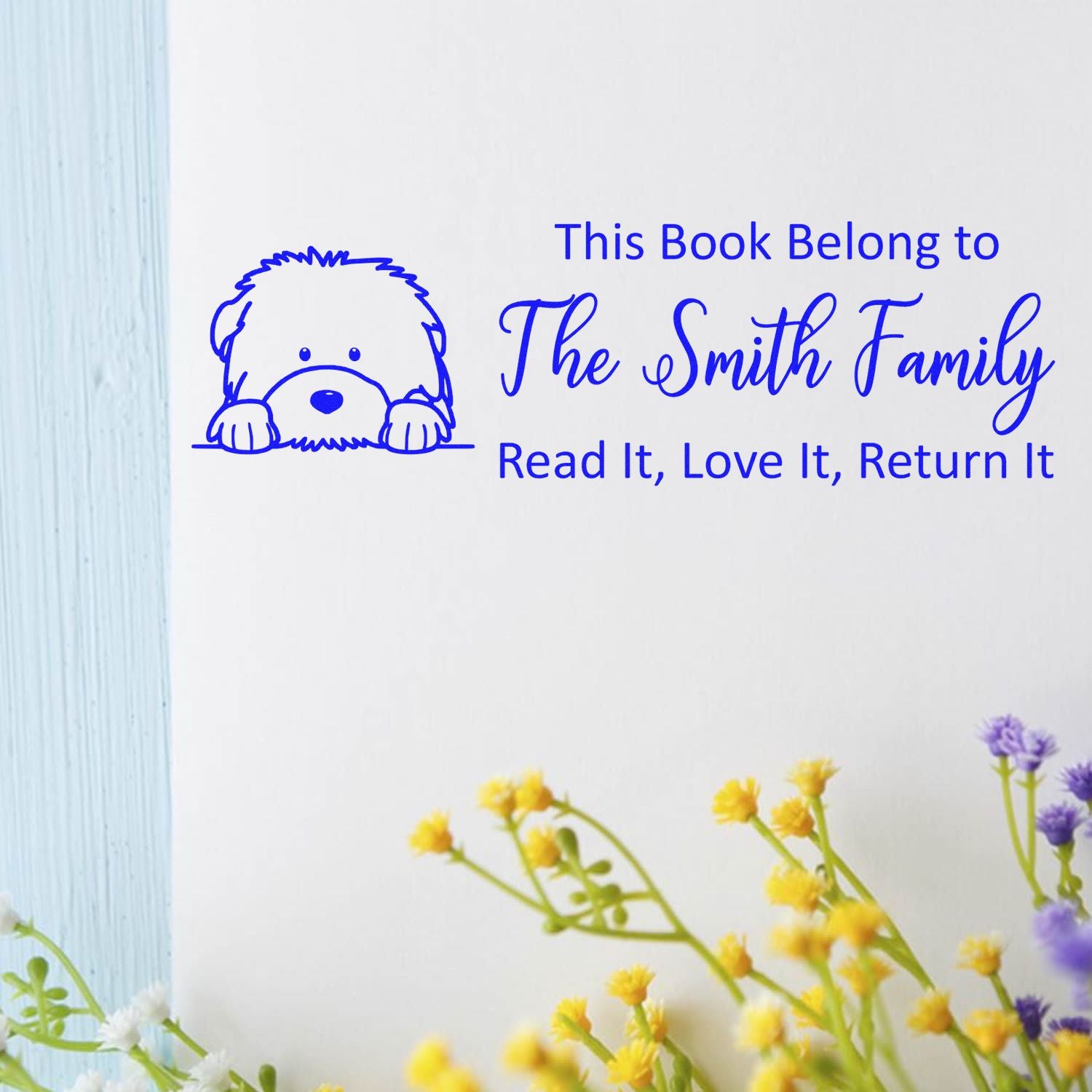 Custom rubber stamp with dog icon and personalized This Book Belong to The Smith Family book return message.