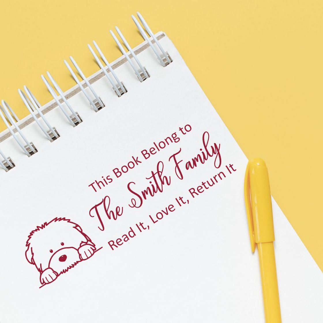 Custom personalized rubber book stamp reading This Book Belongs to The Smith FamilyRead It, Love It, Return It with dog icon.