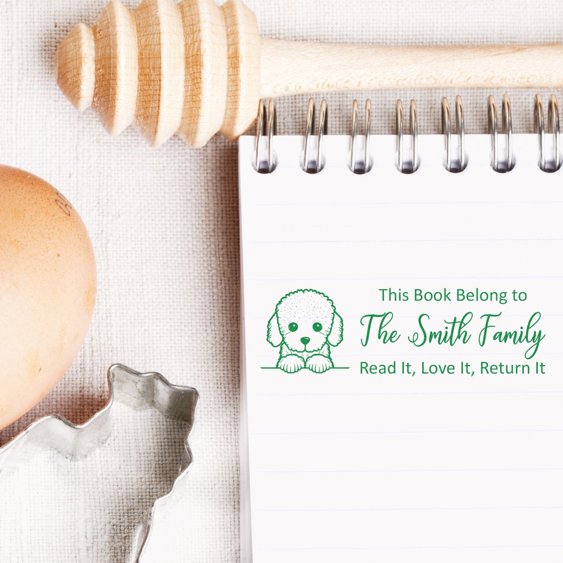 Personalized dog book stamp for home libraries, reading This Book Belongs to The Smith Family and Read It, Love It, Return It.