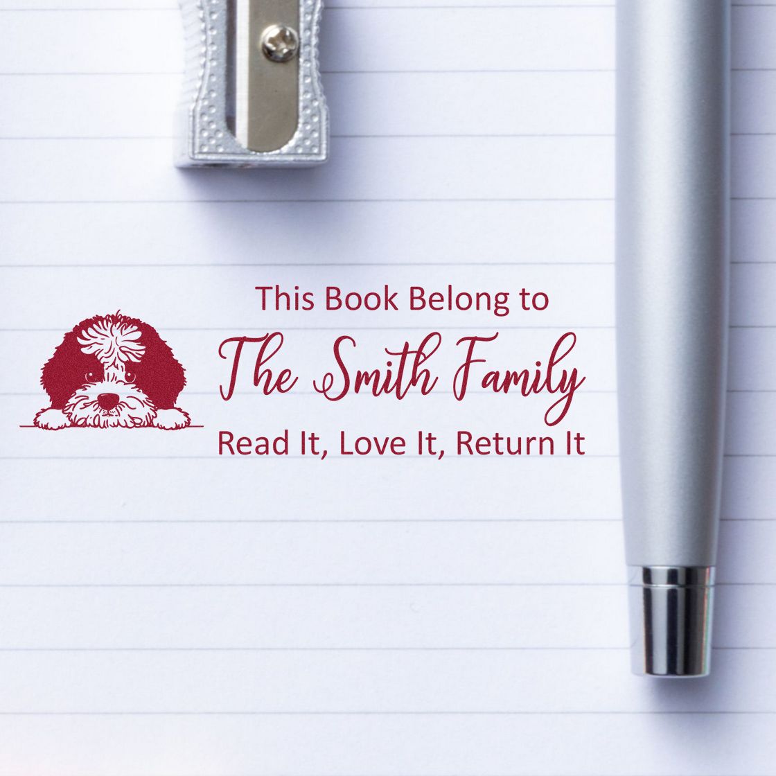 Personalized rubber book stamp for The Smith Family with dog design and Read It, Love It, Return It message.