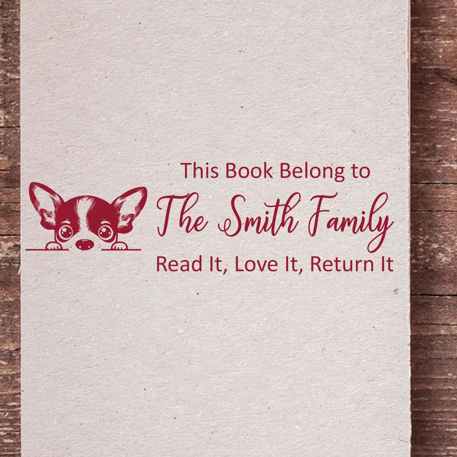 Personalized rubber stamp for books with dog illustration and This Book Belongs to The Smith Family return message.