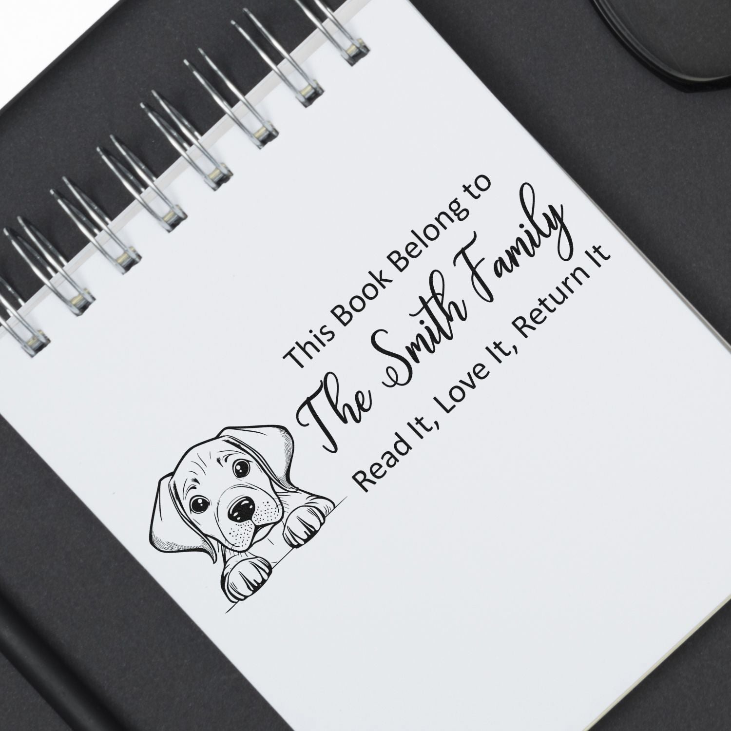 Personalized rubber book stamp for The Smith Family with puppy illustration and Read it, love it, return it message.