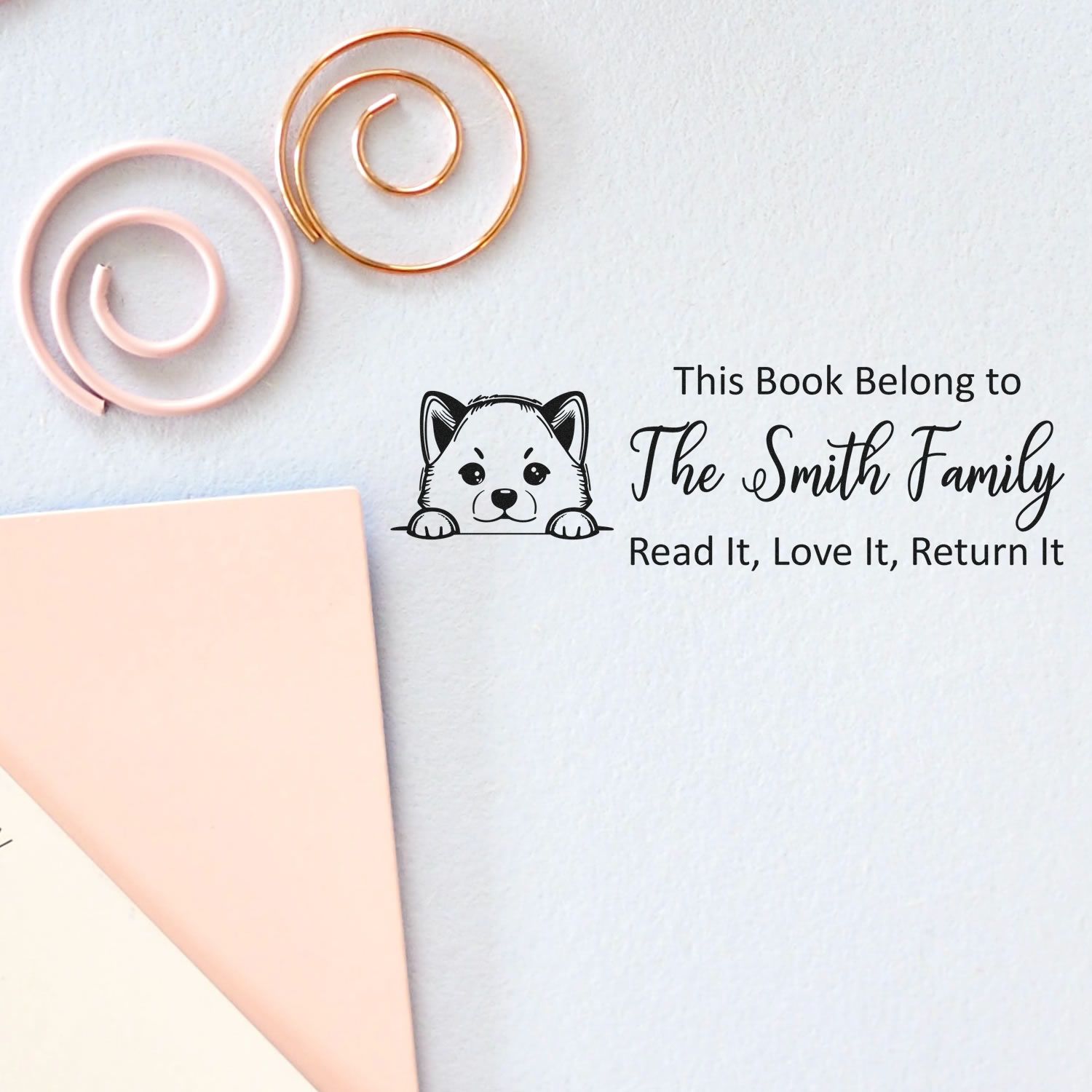 Custom bookplate rubber stamp with dog illustration and personalized This Book Belongs to The Smith Family return message.