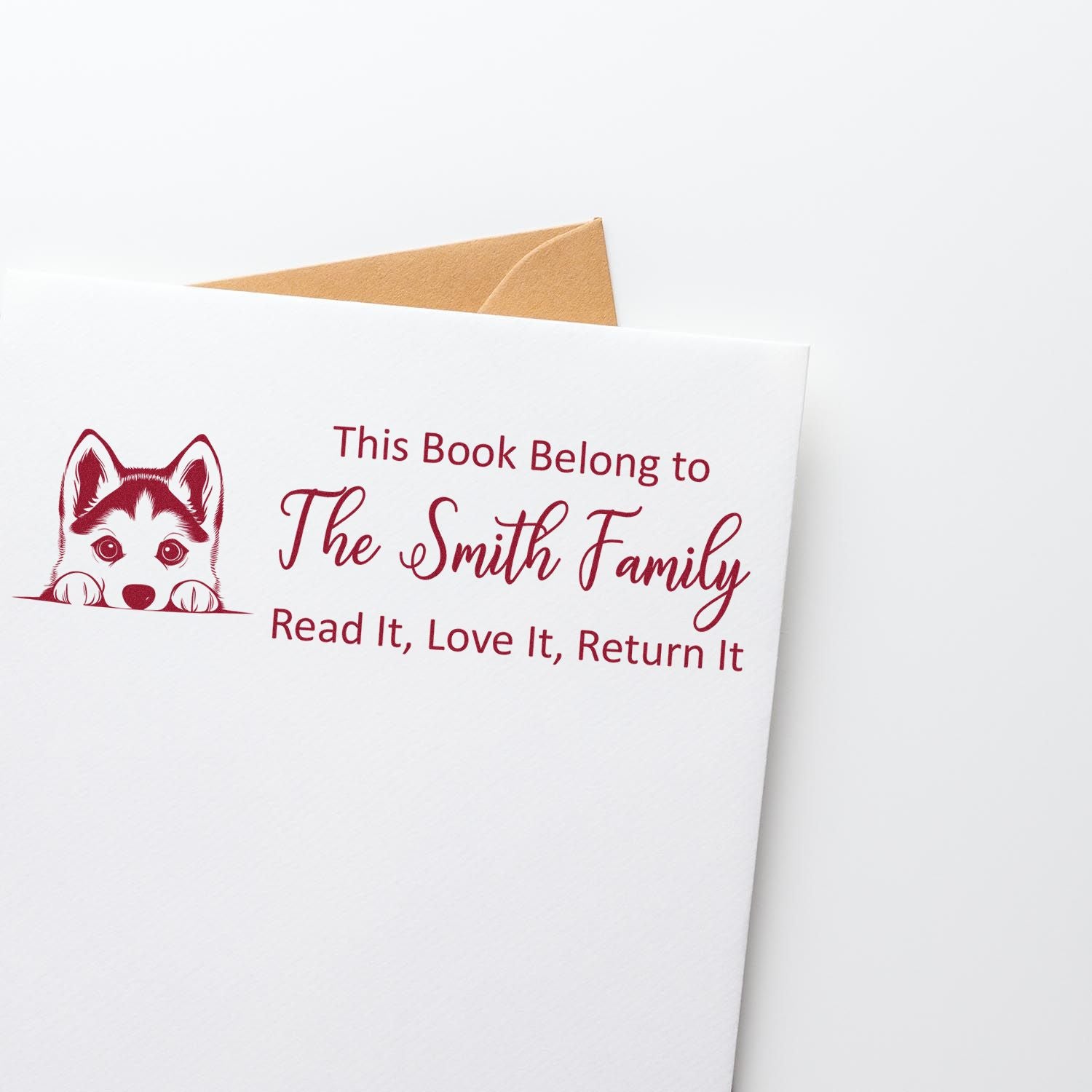 Personalized rubber stamp bookplate with husky design for the Smith family, reading This Book Belong to The Smith Family.