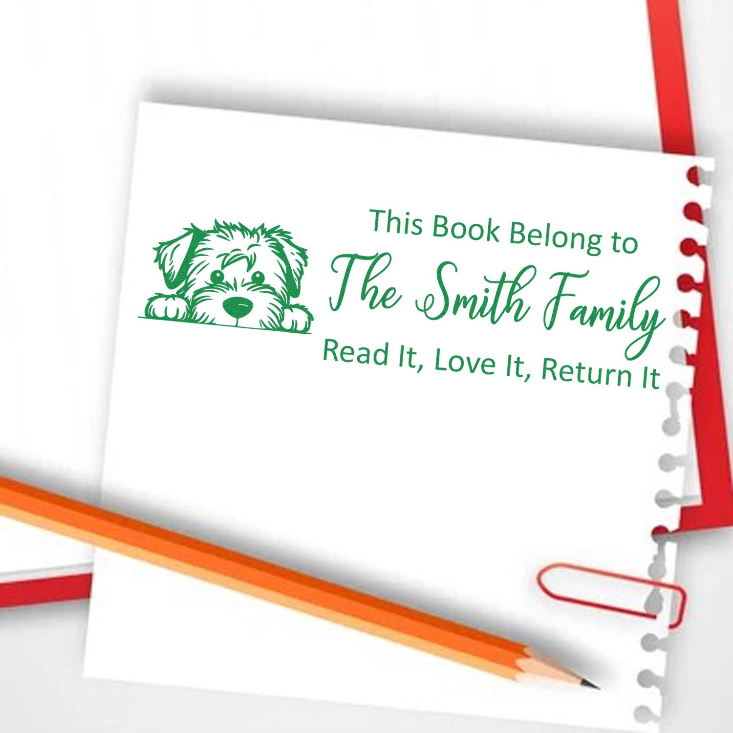 Personalized rubber book stamp with dog illustration and The Smith Family name, reading This Book Belongs to... for library books.