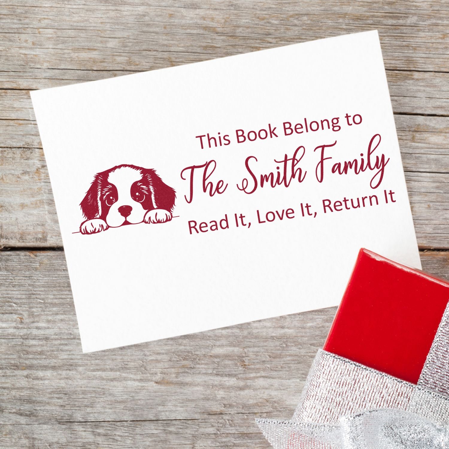 Personalized rubber book stamp with dog illustration and This Book Belongs to The Smith Family return message