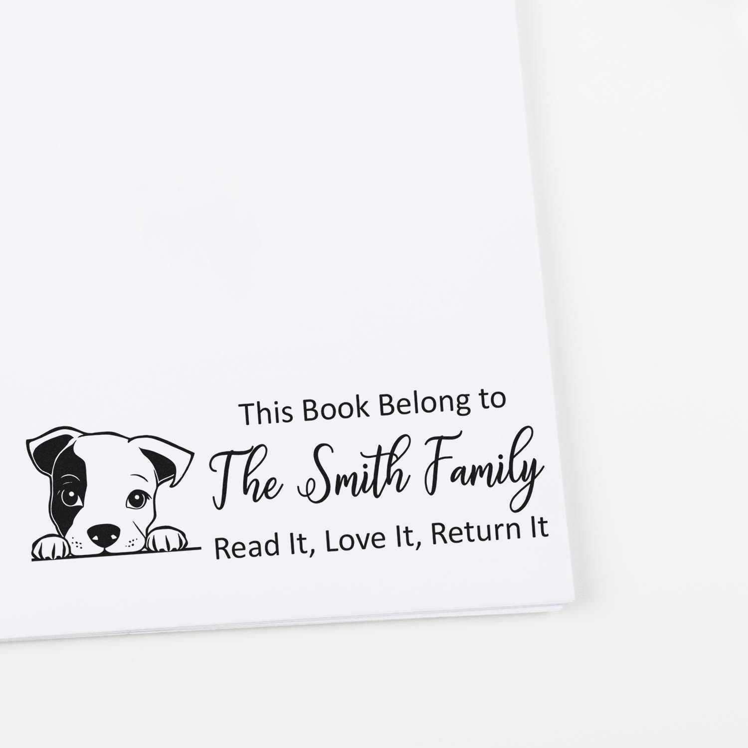 Custom personalized book stamp with dog illustration for The Smith Family, reading "Read It, Love It, Return It.