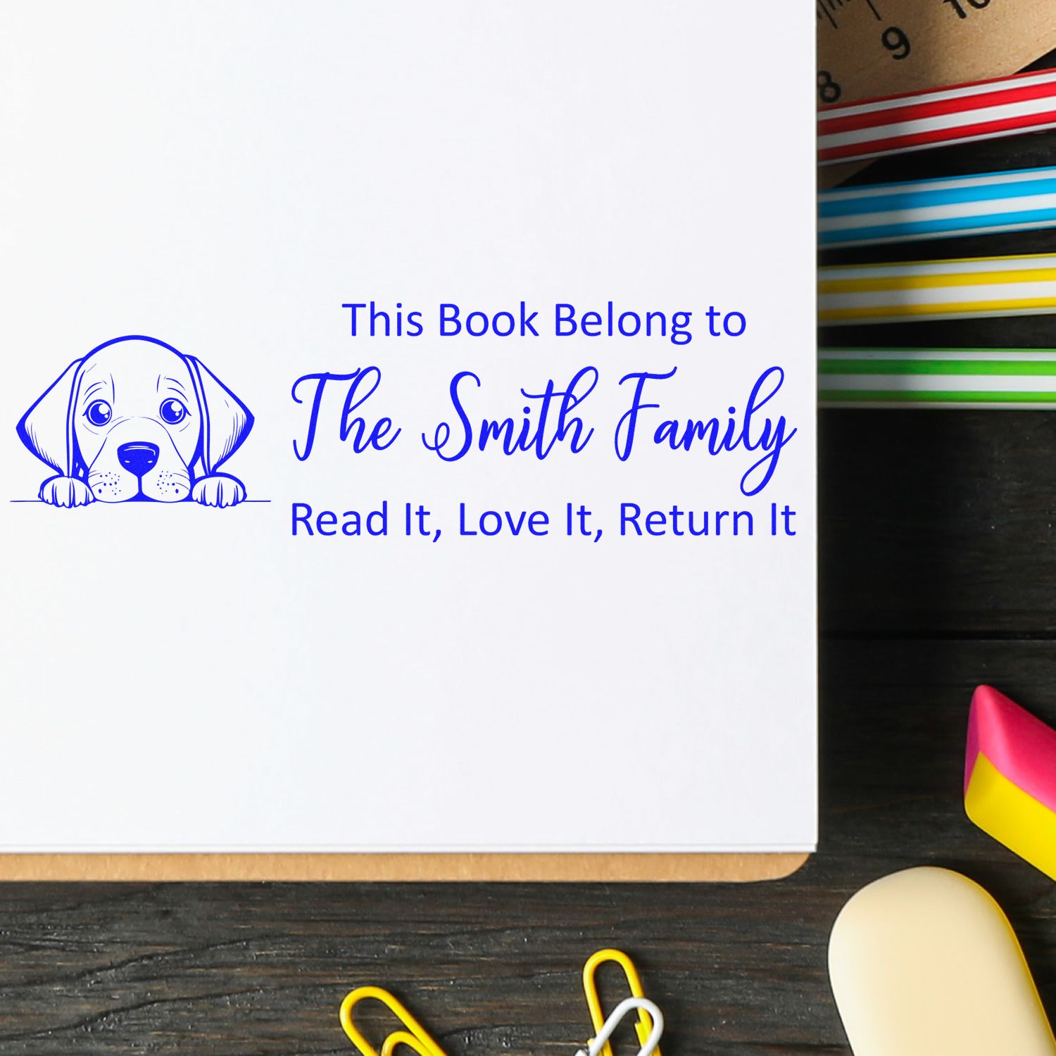 Personalized rubber book stamp with puppy design for This Book Belongs to The Smith Family book return labeling.