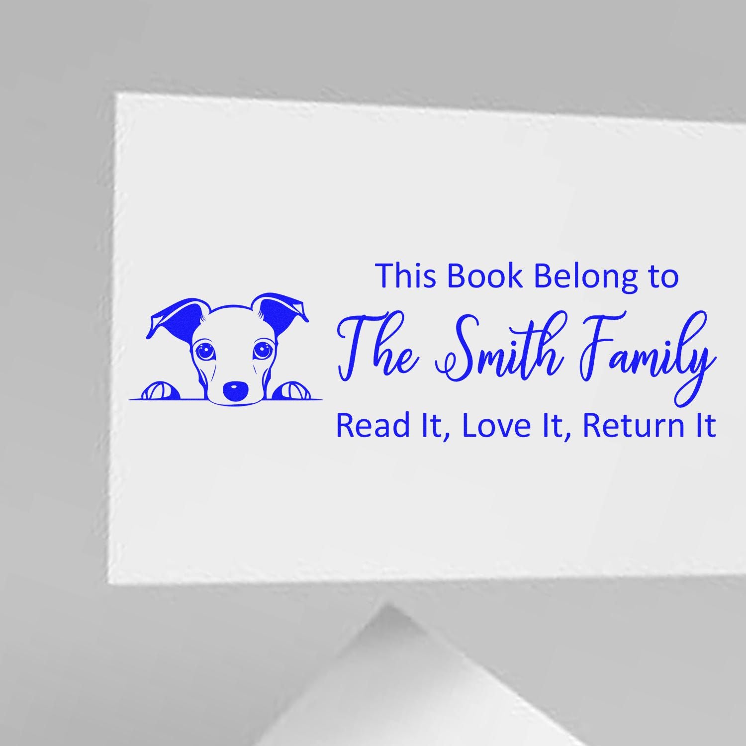 Personalized book rubber stamp with dog illustration: This Book Belongs to The Smith Family, Read It, Love It, Return It.