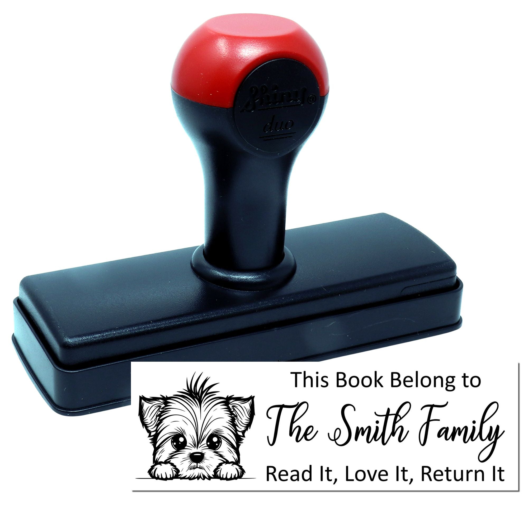 Custom self-inking rubber book stamp with dog design and This Book Belong to The Smith Family return-it message.