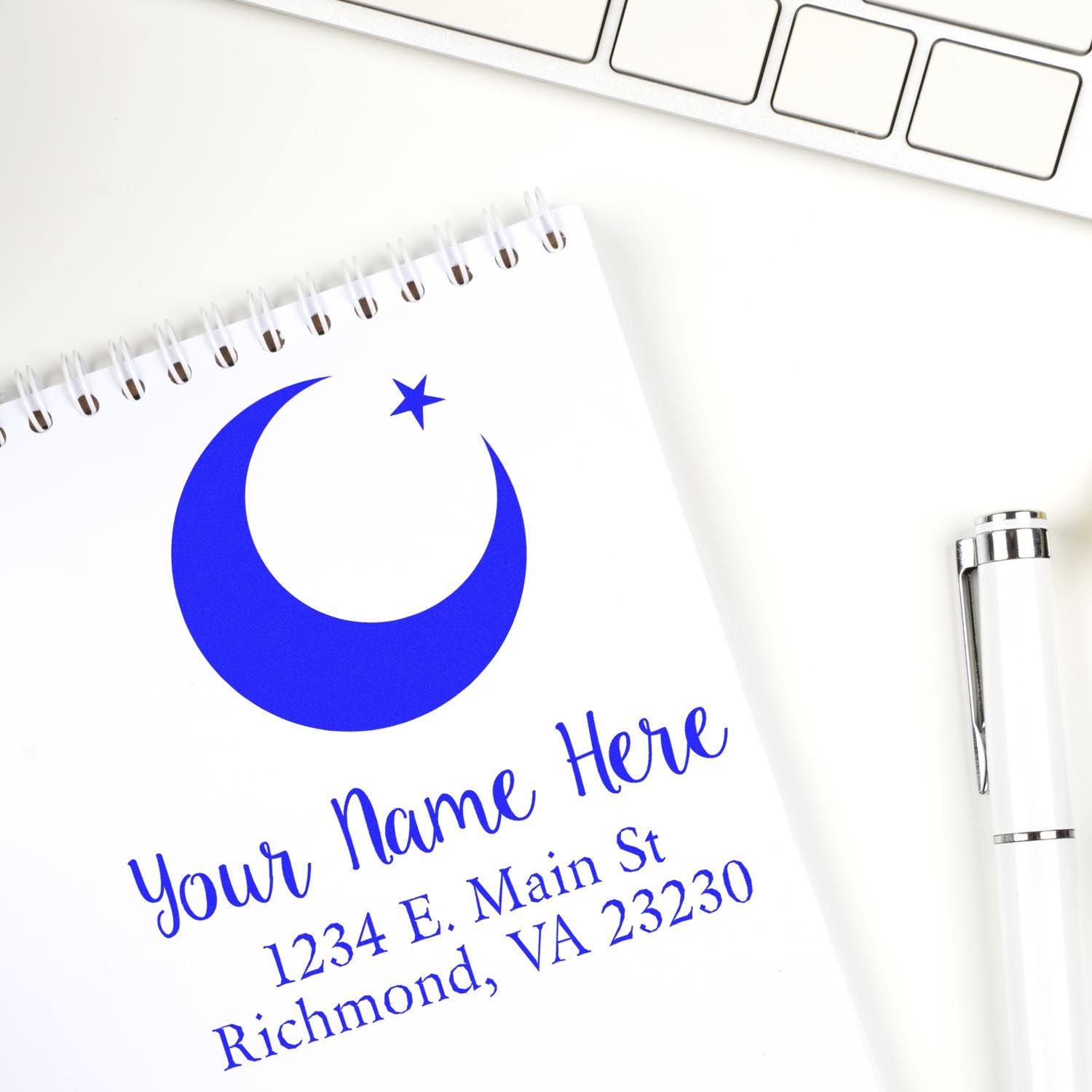 Personalized custom rubber stamp with logo and address on notebook, ideal for business branding.