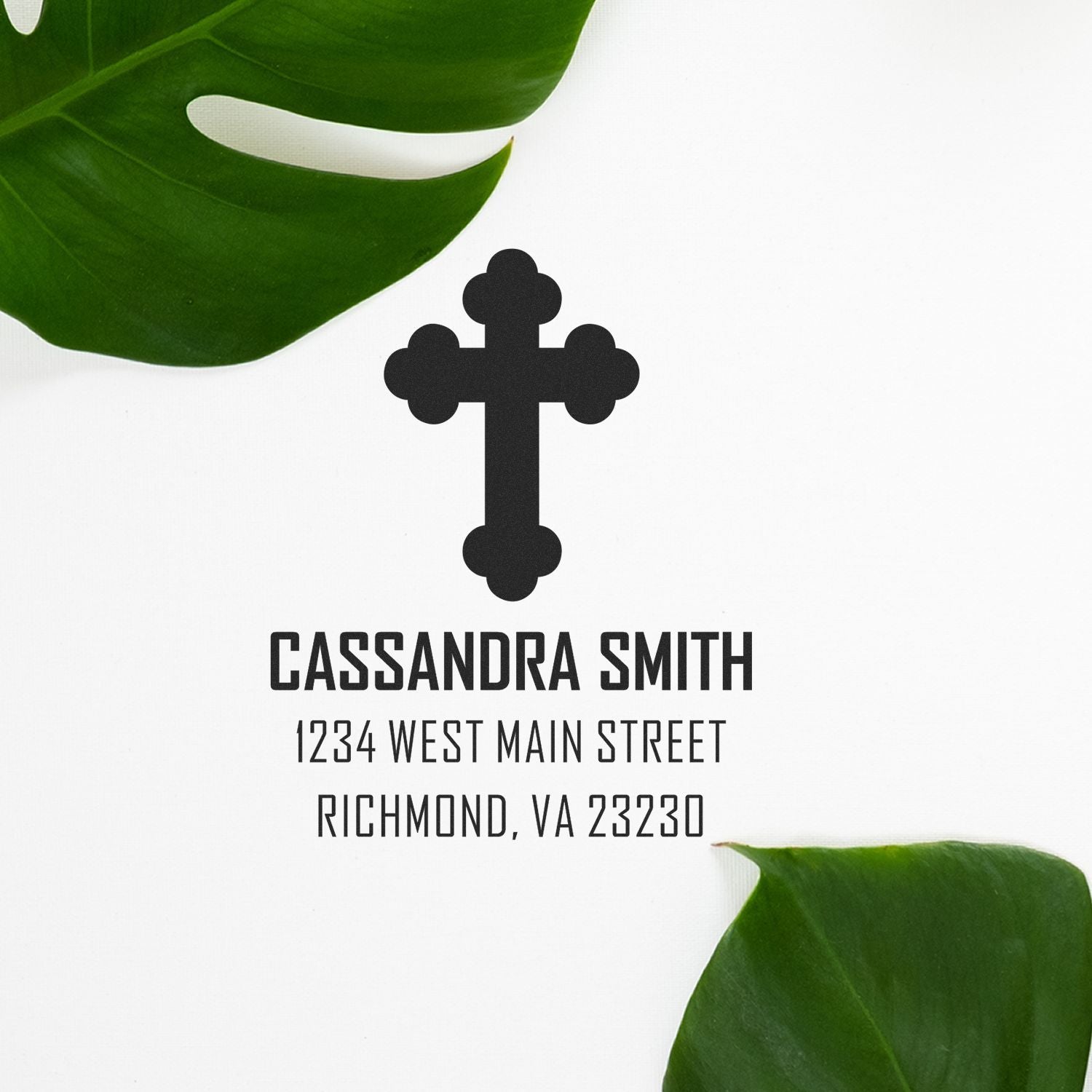 Custom rubber stamp with cross logo, Cassandra Smith name, and return address for faith-based mail and stationery.