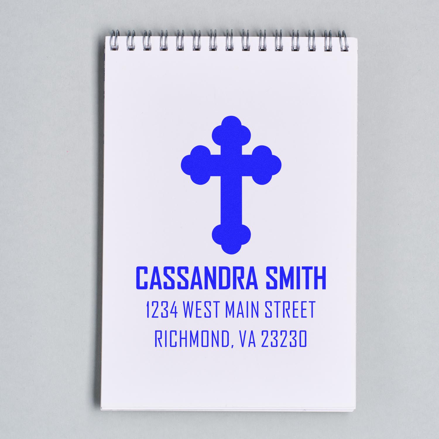 Personalized address rubber stamp with blue cross logo, Cassandra Smith name, and Richmond, VA return address.