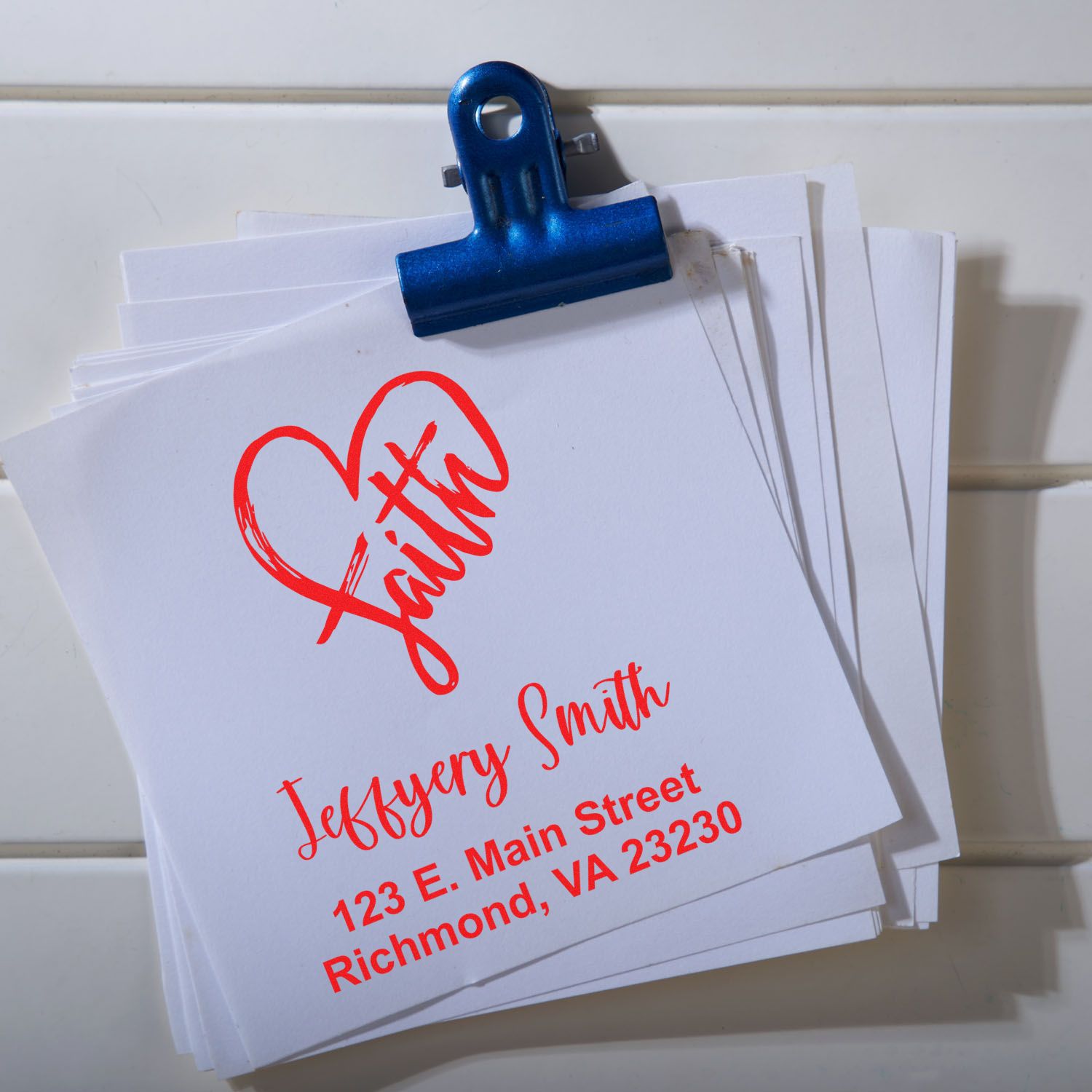Custom faith address rubber stamp imprint on papers for personalized mailing and office use.