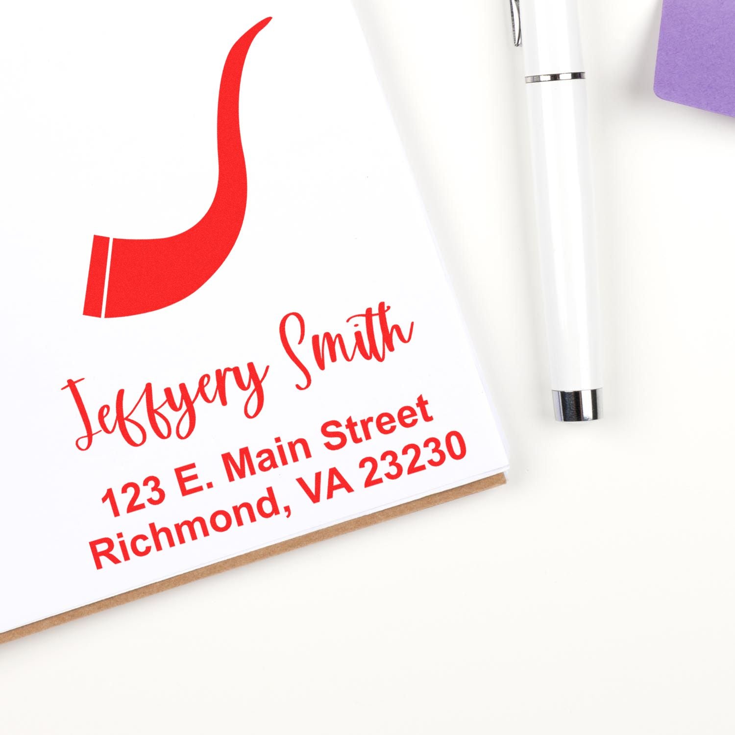 Custom return address rubber stamp for Jeffery Smith, Richmond, VA, displayed with pen and stationery.