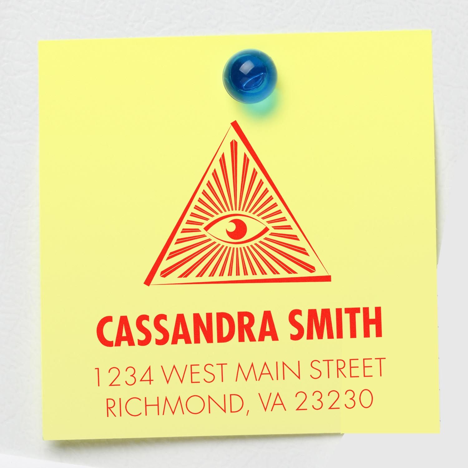 Custom return address rubber stamp with all-seeing eye logo, Cassandra Smith, and Richmond, VA address on yellow note.