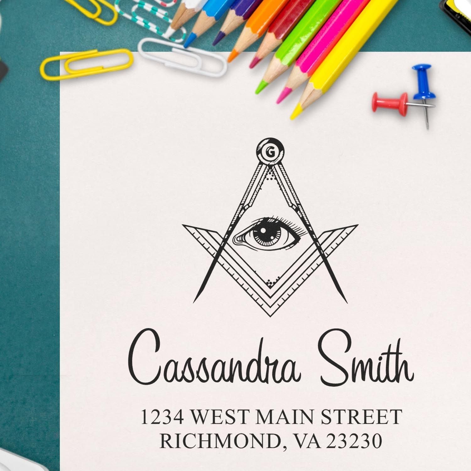 Custom rubber return address stamp with compass eye design for personalized stationery and mailing.