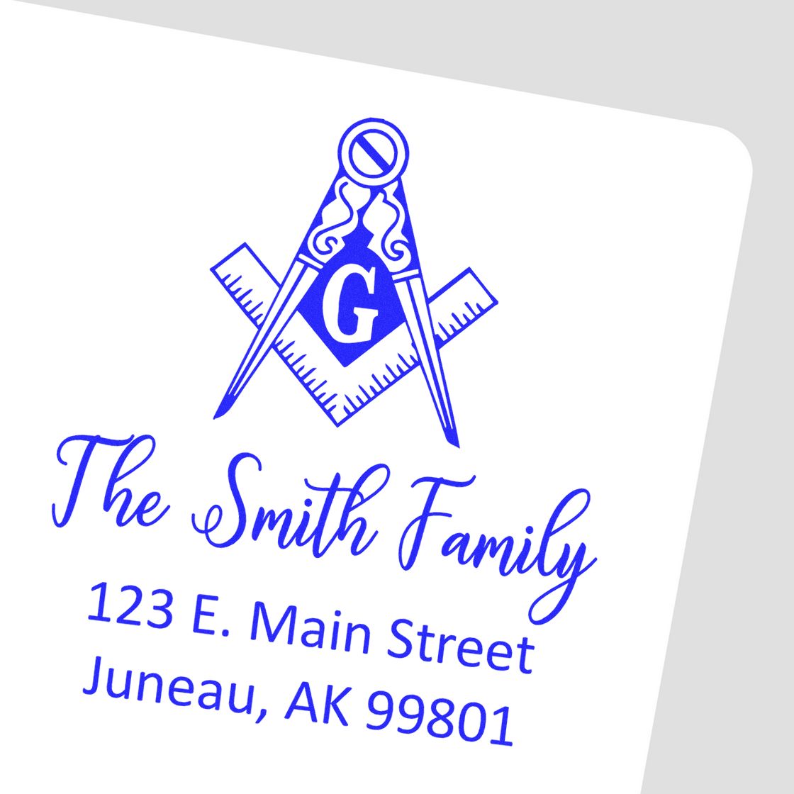 Custom return address rubber stamp for The Smith Family, 123 E. Main Street, Juneau, AK 99801 with compass logo