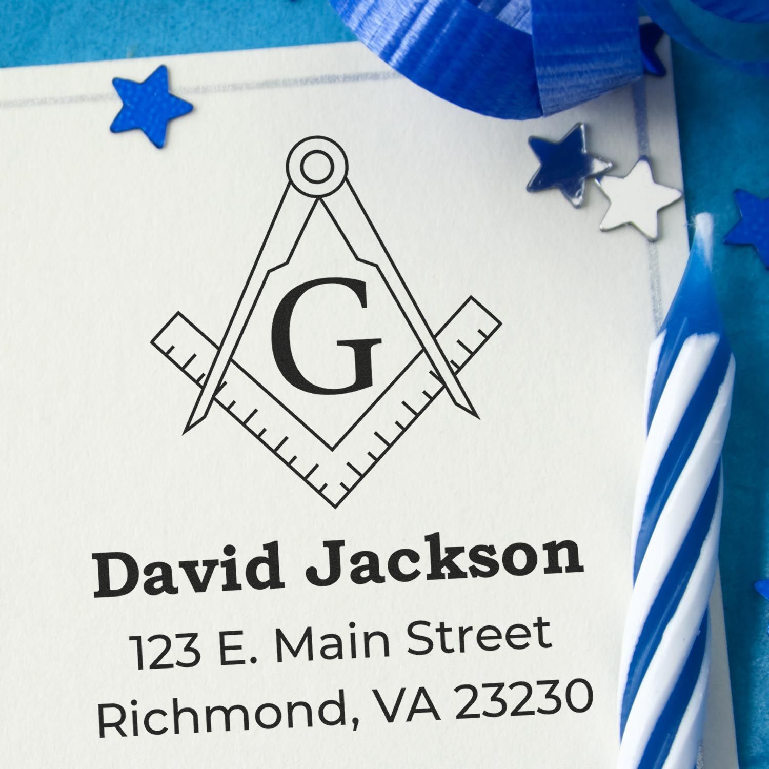 Custom Masonic return address rubber stamp for David Jackson with compass and square monogram.