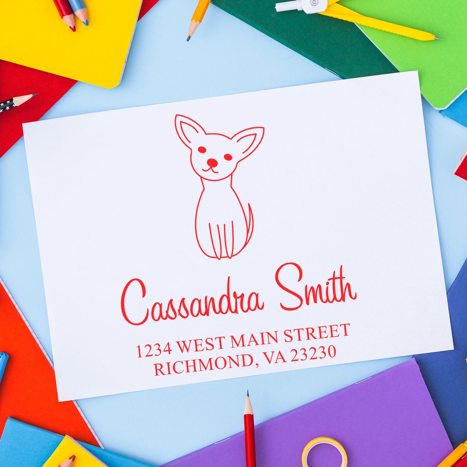Custom return address rubber stamp with dog logo on stationery, used for personalized envelopes and mailings.