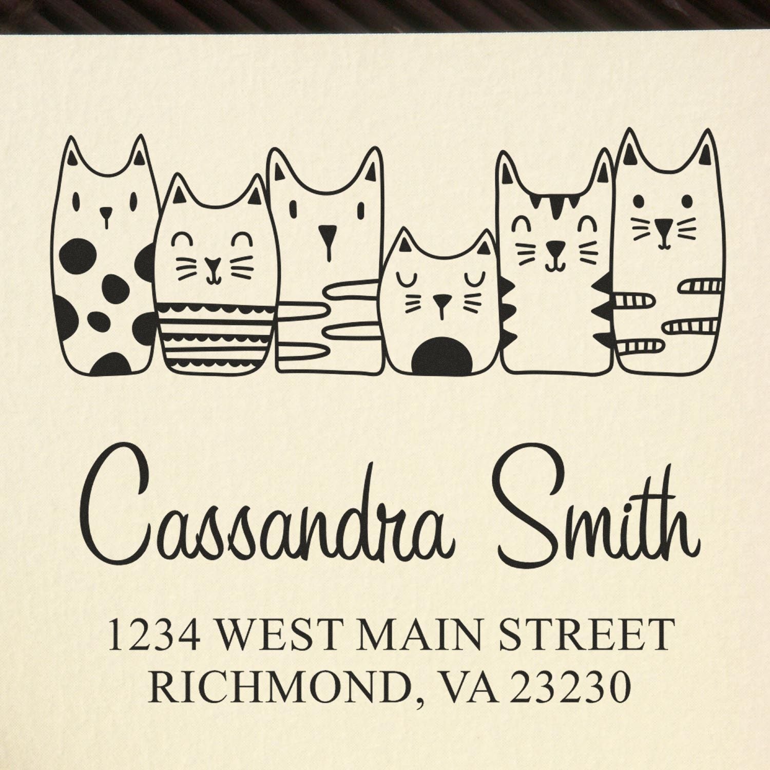 Custom cat-themed address rubber stamp for Cassandra Smith, with six cats and Richmond, VA return address.