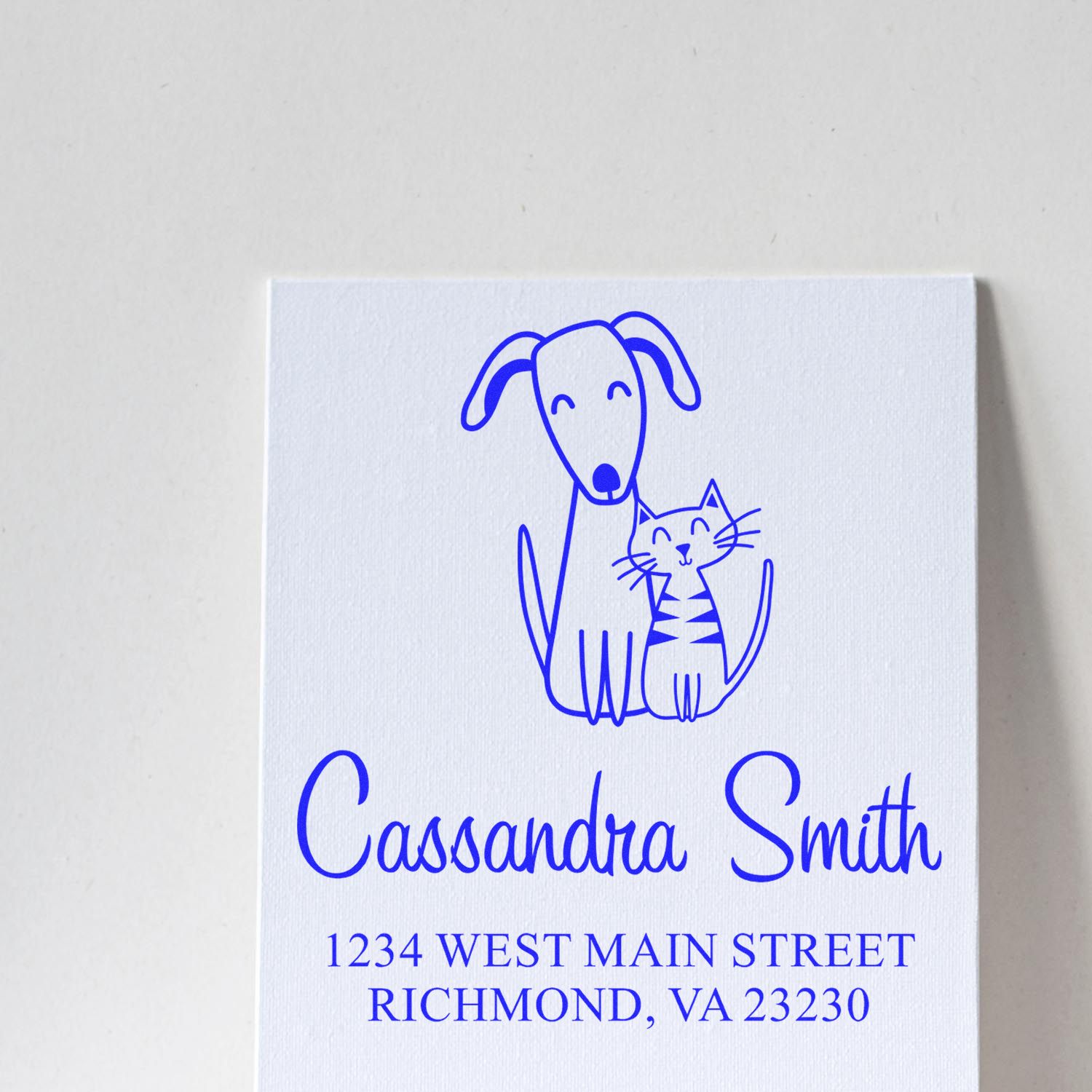 Custom pet-themed return address rubber stamp for Cassandra Smith, Richmond, VA 23230, with dog and cat illustration.