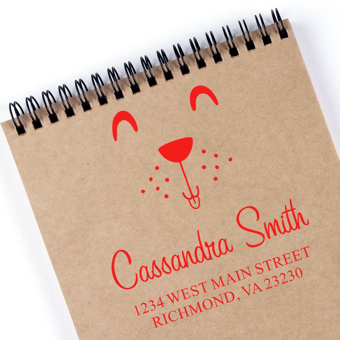 Personalized return address rubber stamp with name and address stamped on kraft notebook for mailing and packaging.