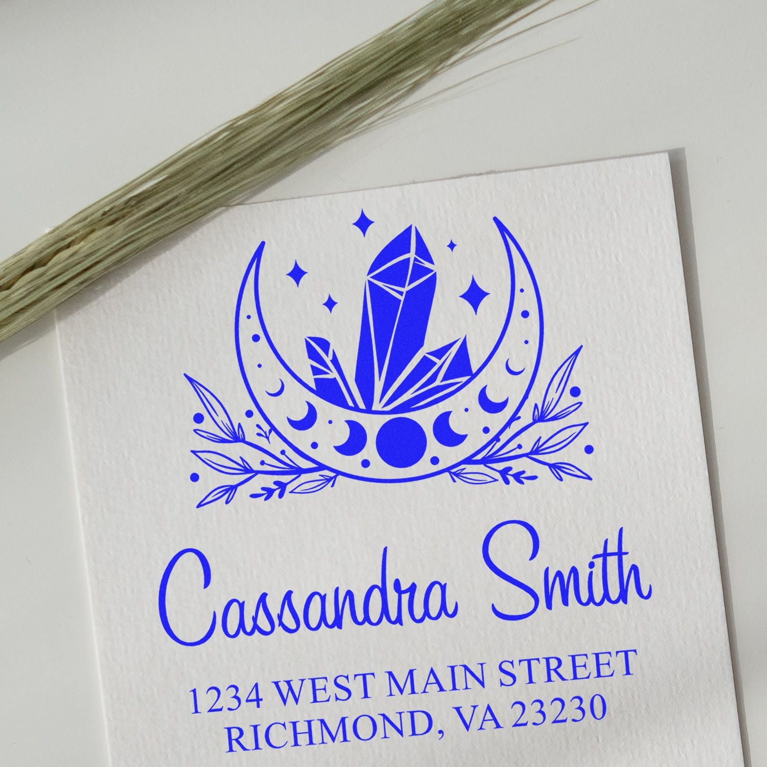 Custom rubber stamp with moon crystal logo, Cassandra Smith name, and address for personalized return mail.