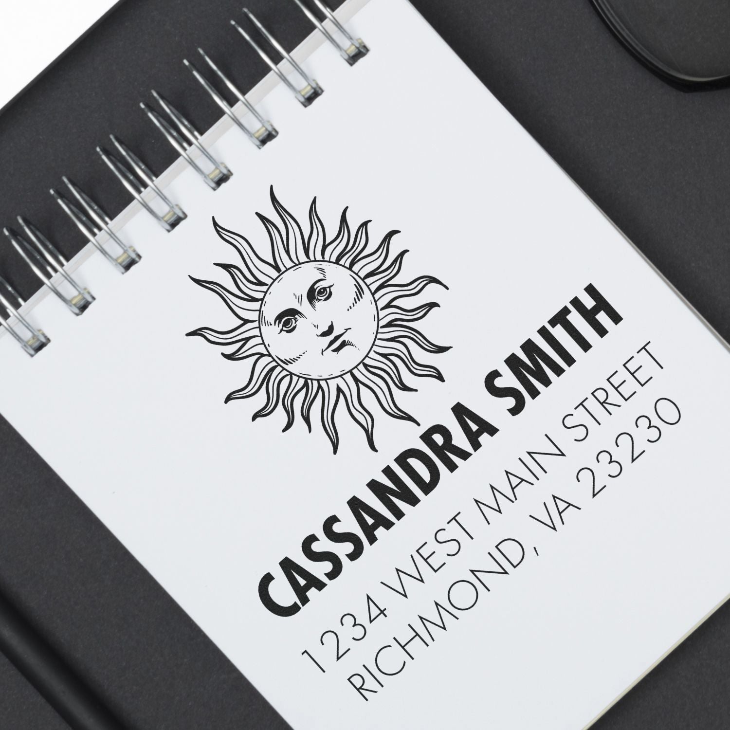 Custom return address rubber stamp with sun logo for Cassandra Smith, 1234 West Main Street, Richmond, VA 23230.