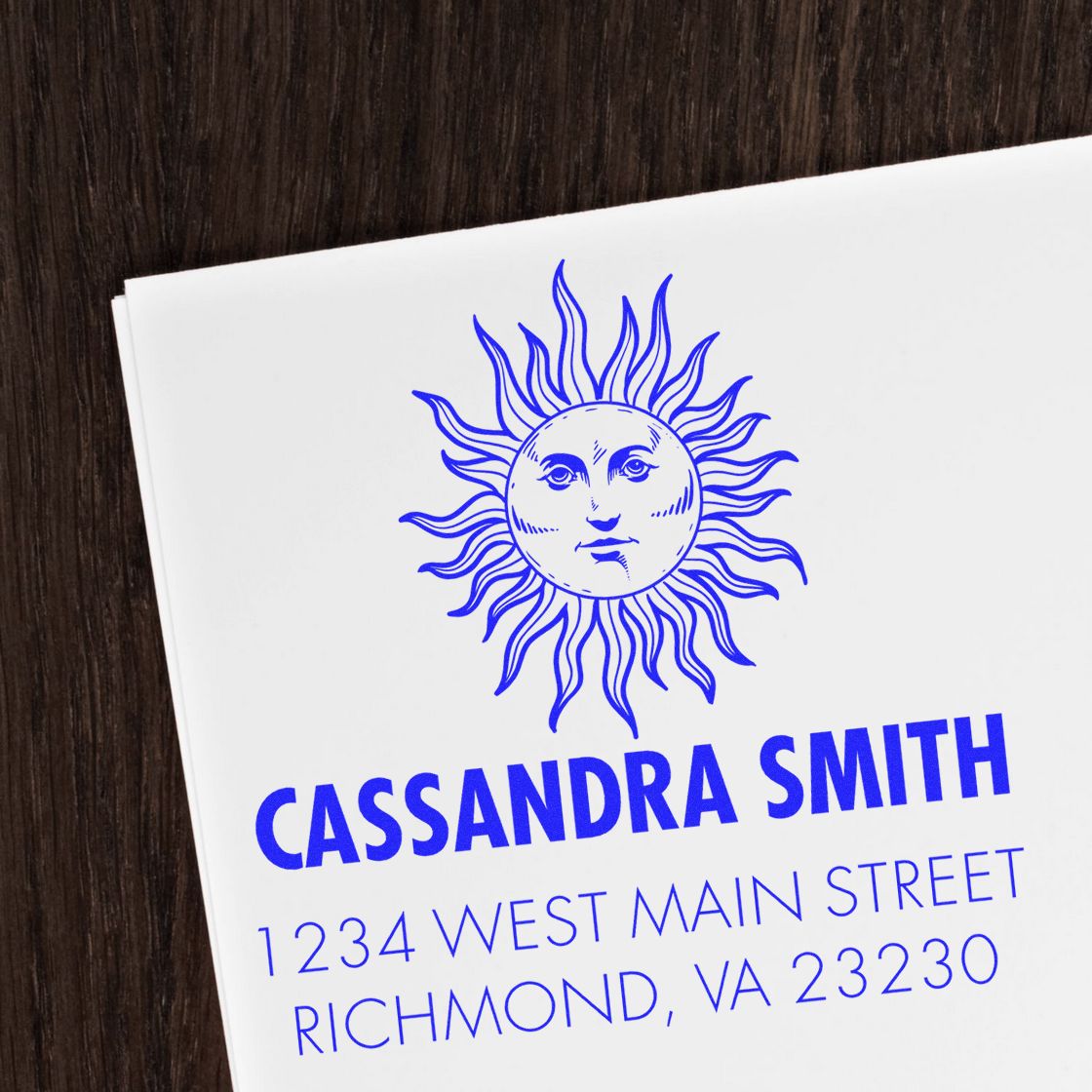 Personalized rubber stamp return address with sun logo, Cassandra Smith, and Richmond, VA mailing details.
