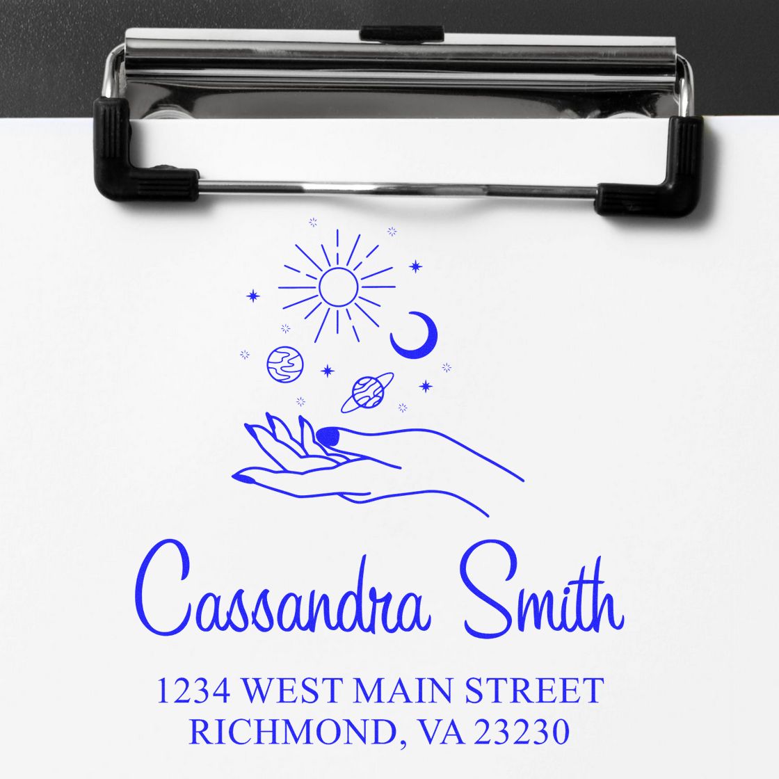 Custom rubber stamp design with name, address, and celestial hand icon for Cassandra Smith return mail.