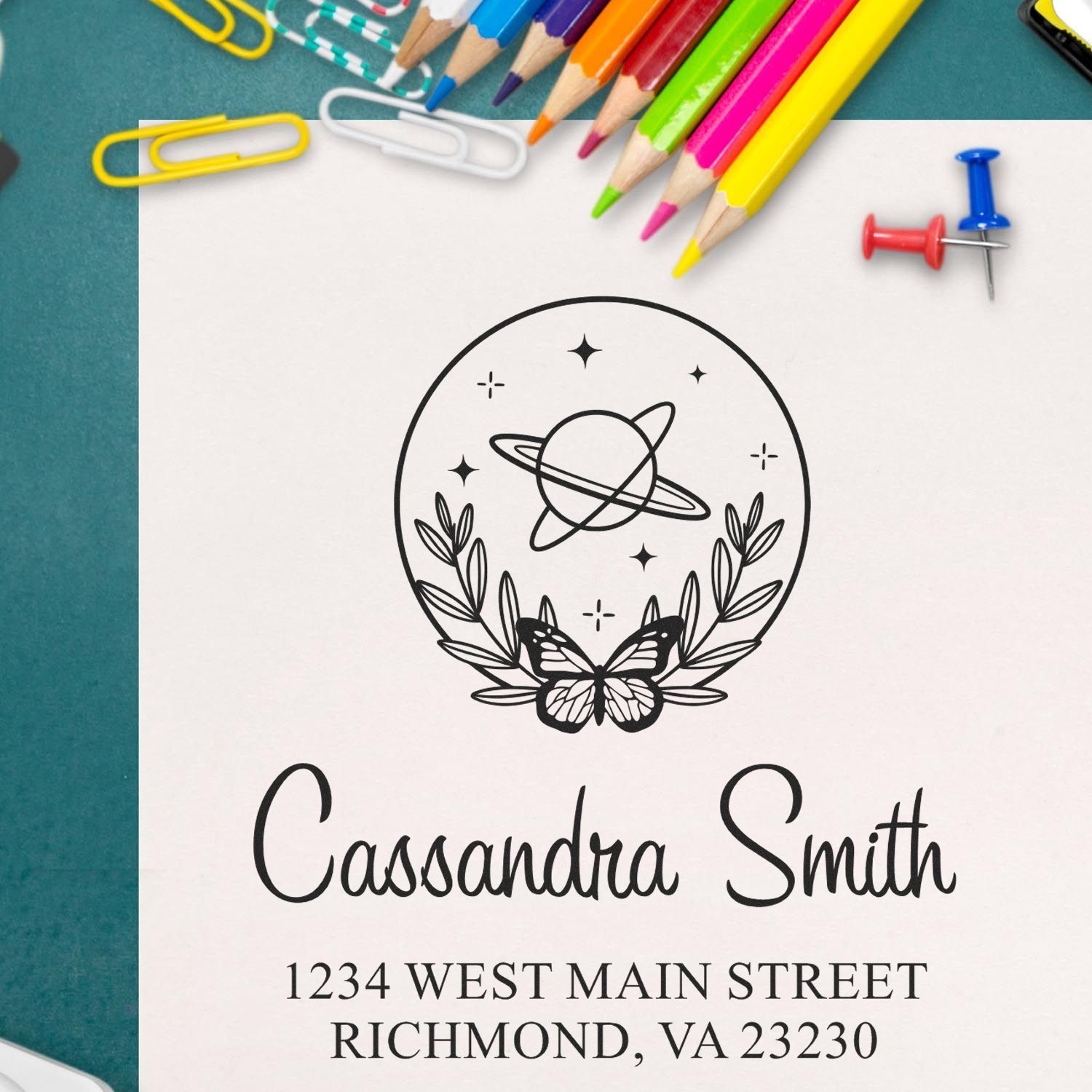Custom return address rubber stamp with celestial butterfly logo, name, and Richmond, VA address on stationery.