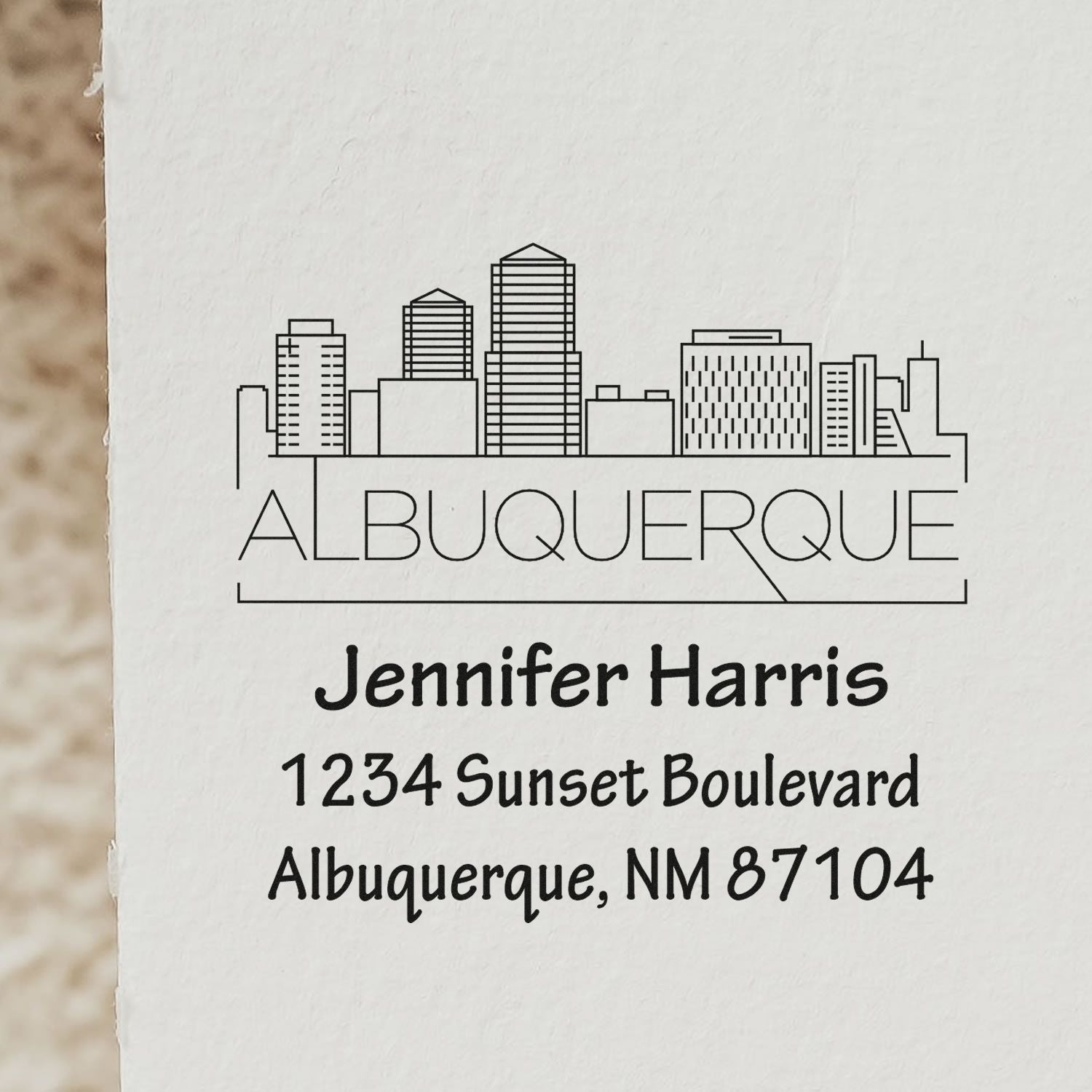 Custom Albuquerque skyline return address rubber stamp for Jennifer Harris, 1234 Sunset Boulevard, Albuquerque, NM 87104.