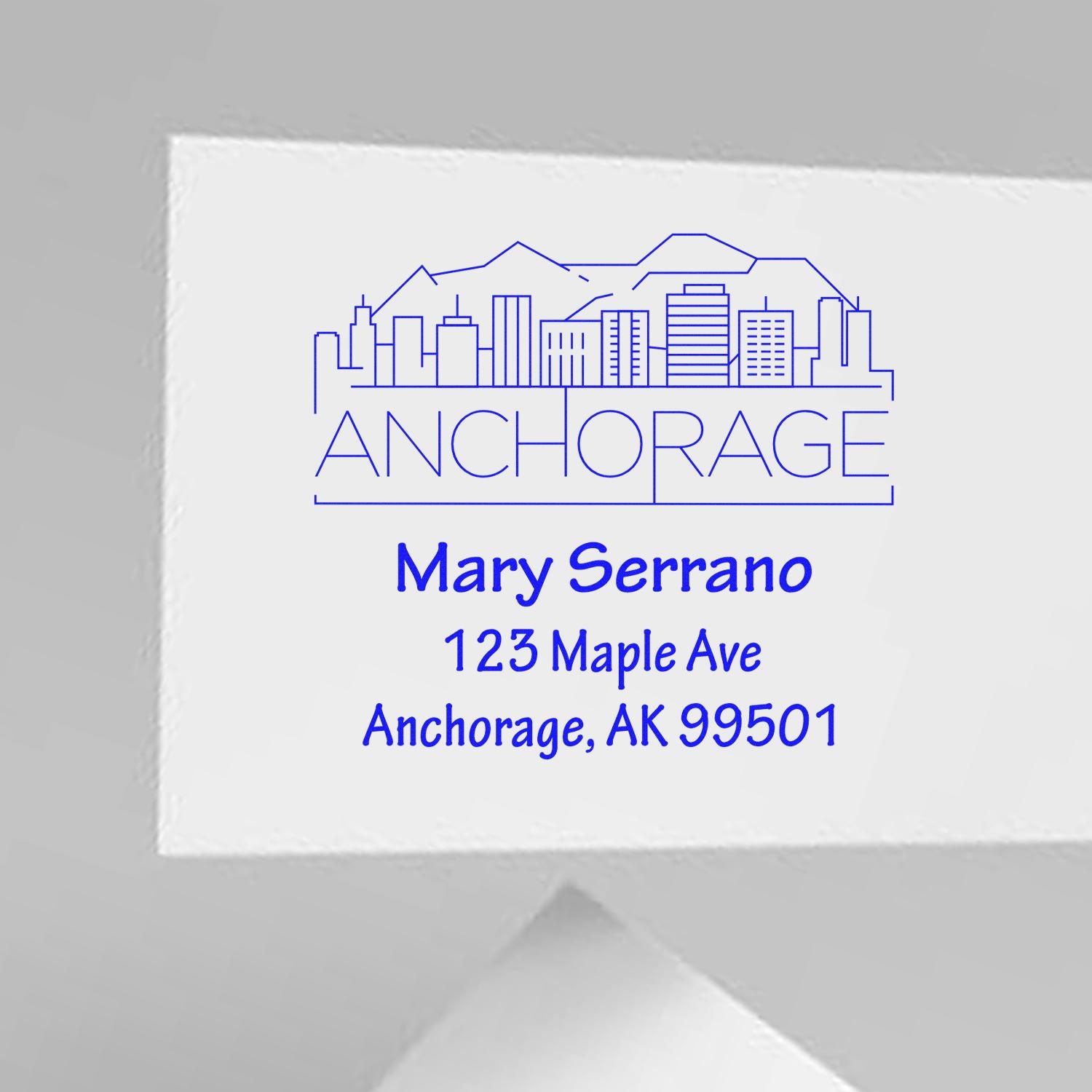 Custom Anchorage address rubber stamp with skyline logo for Mary Serrano, 123 Maple Ave, Anchorage, AK 99501.