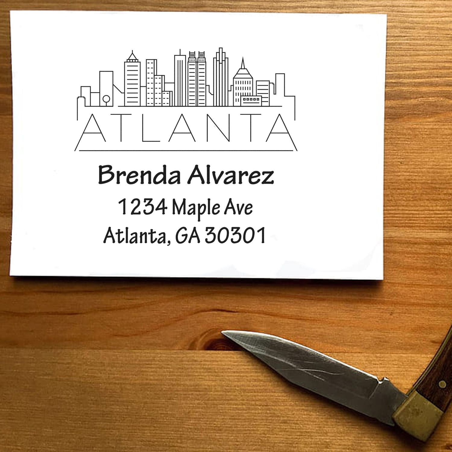 Custom Atlanta address rubber stamp with skyline design, personalized for Brenda Alvarez, 1234 Maple Ave, Atlanta, GA 30301.