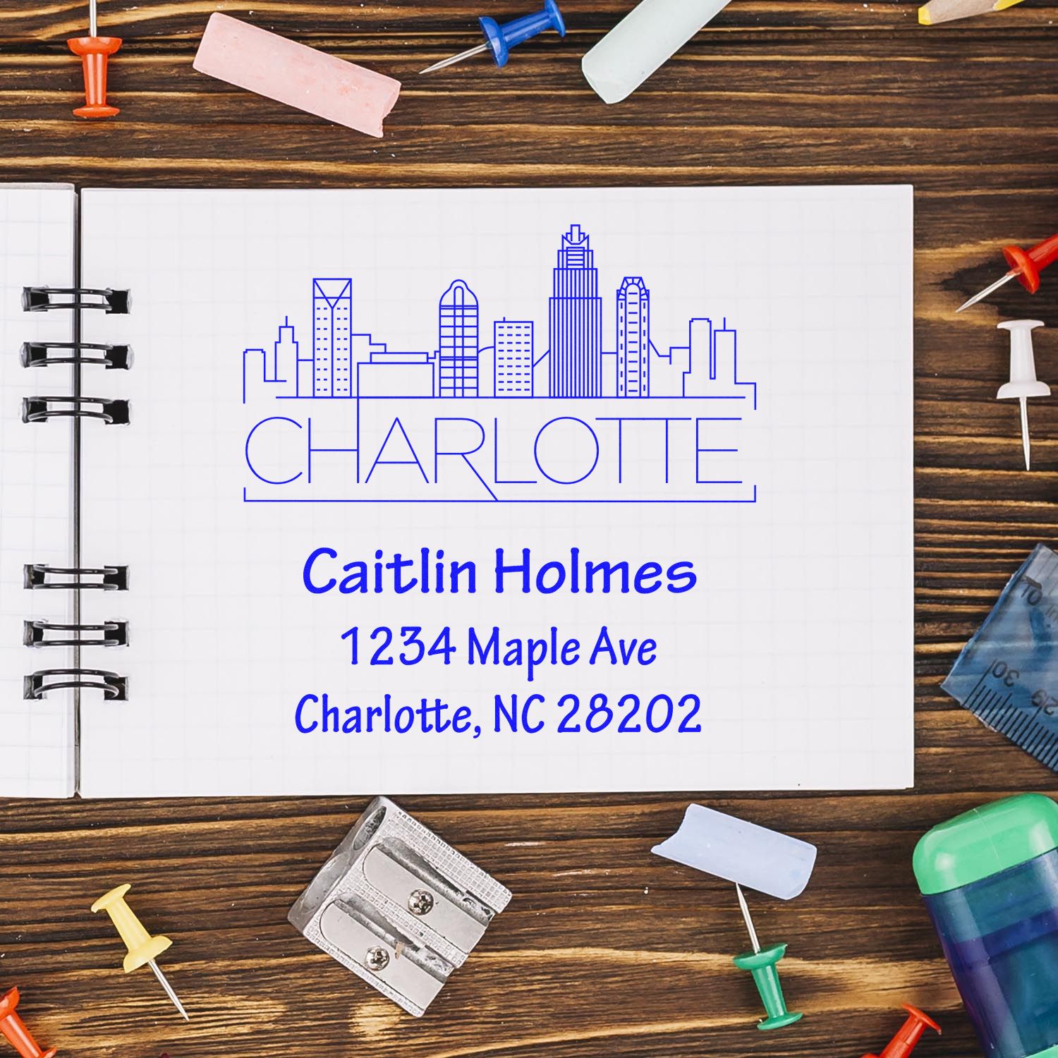Custom Charlotte rubber stamp design with city skyline and personalized return address for Caitlin Holmes.