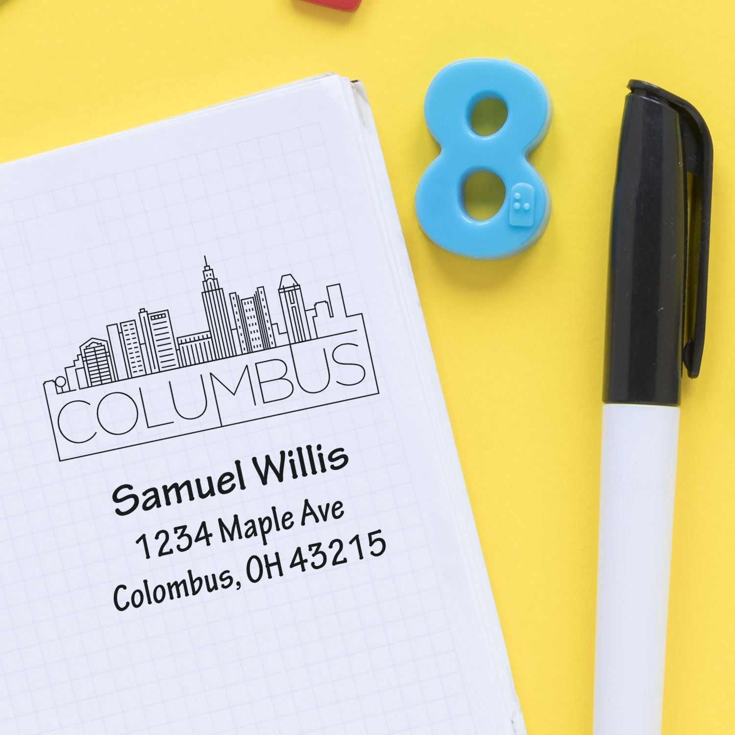 Custom address rubber stamp with Columbus, Ohio skyline imprint on notebook; personalized mail stamp for business.