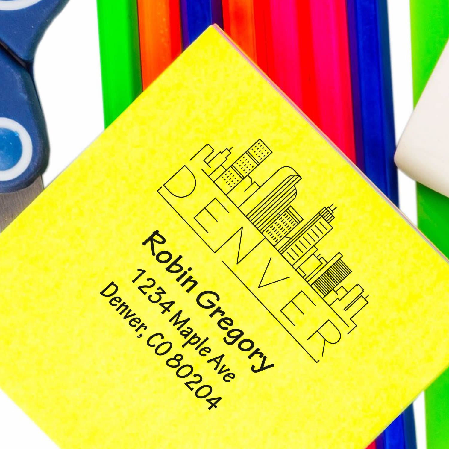 Custom rubber stamp featuring Robin Gregorys Denver return address and skyline logo for mailing and branding.