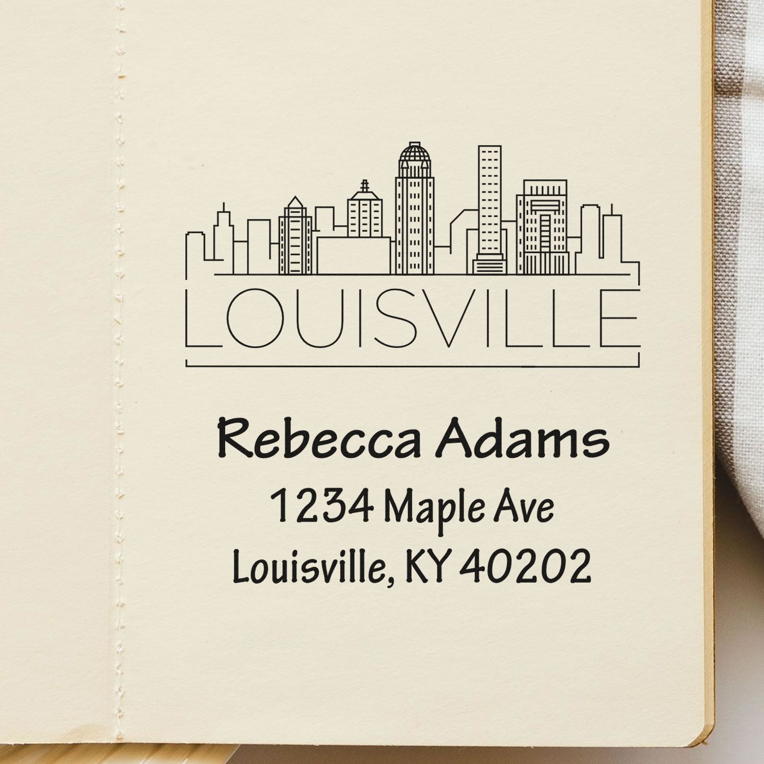Personalized Louisville rubber stamp with skyline, Rebecca Adams name, and address, 1234 Maple Ave, Louisville, KY 40202.
