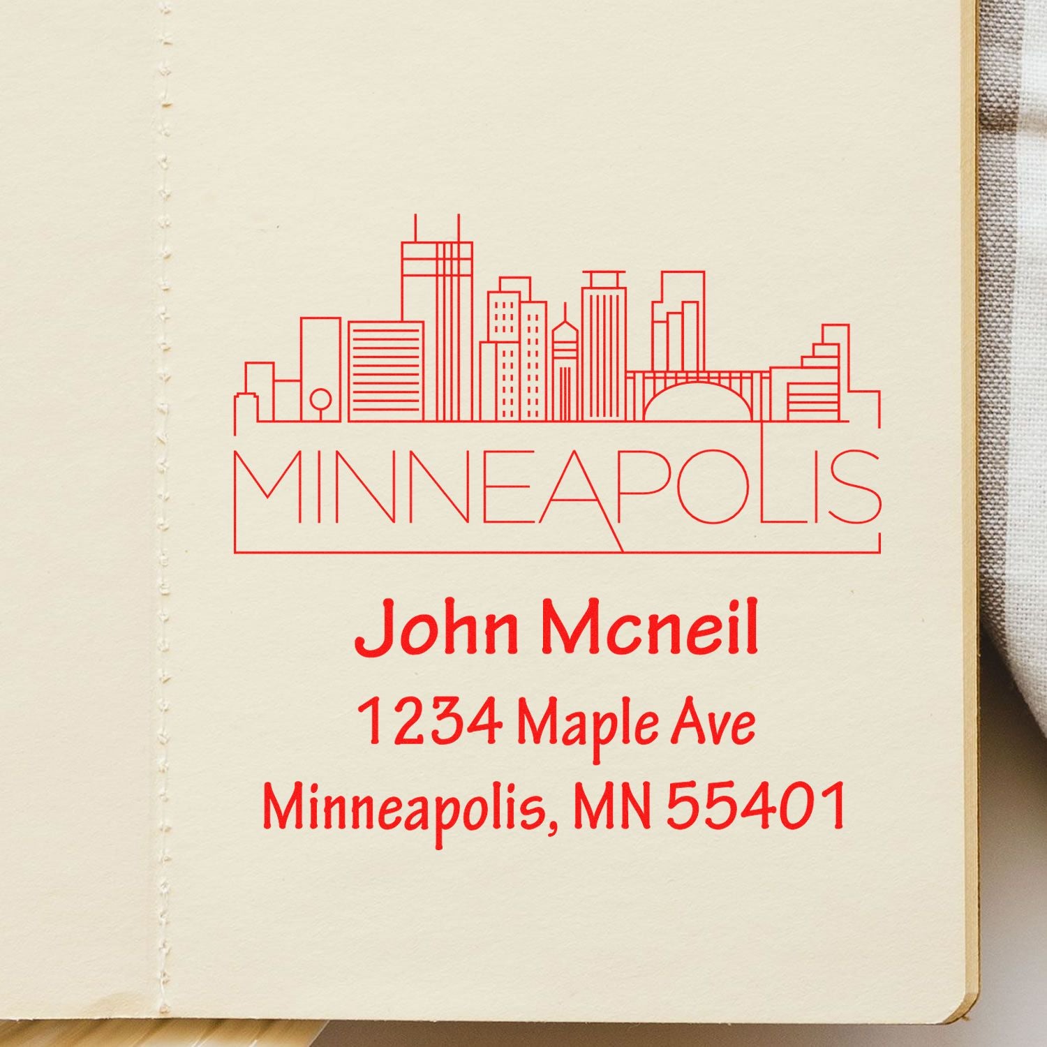 Personalized Minneapolis rubber stamp with skyline and return address for John McNeil, 1234 Maple Ave, Minneapolis, MN 55401.