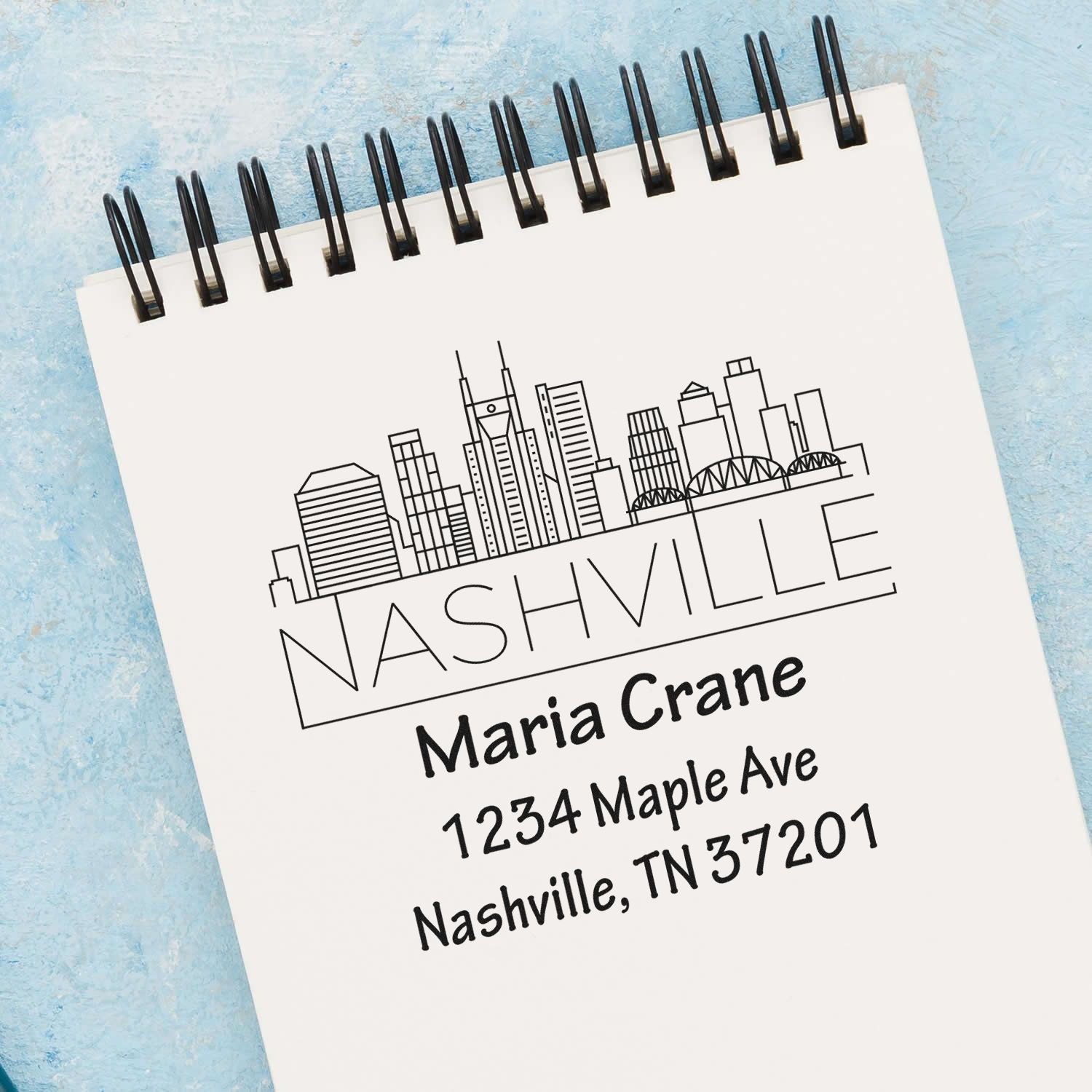 Custom Nashville address rubber stamp with skyline for personal stationery, featuring Maria Crane, 1234 Maple Ave, Nashville, TN 37201.