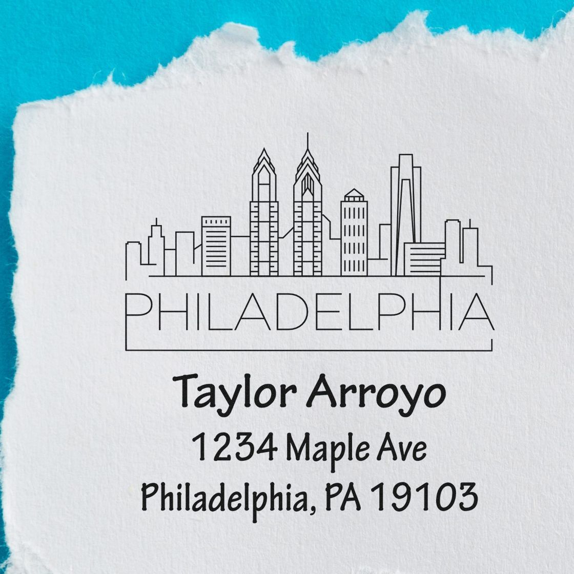 Custom Philadelphia address rubber stamp with skyline and return address for Taylor Arroyo, 1234 Maple Ave, PA 19103.