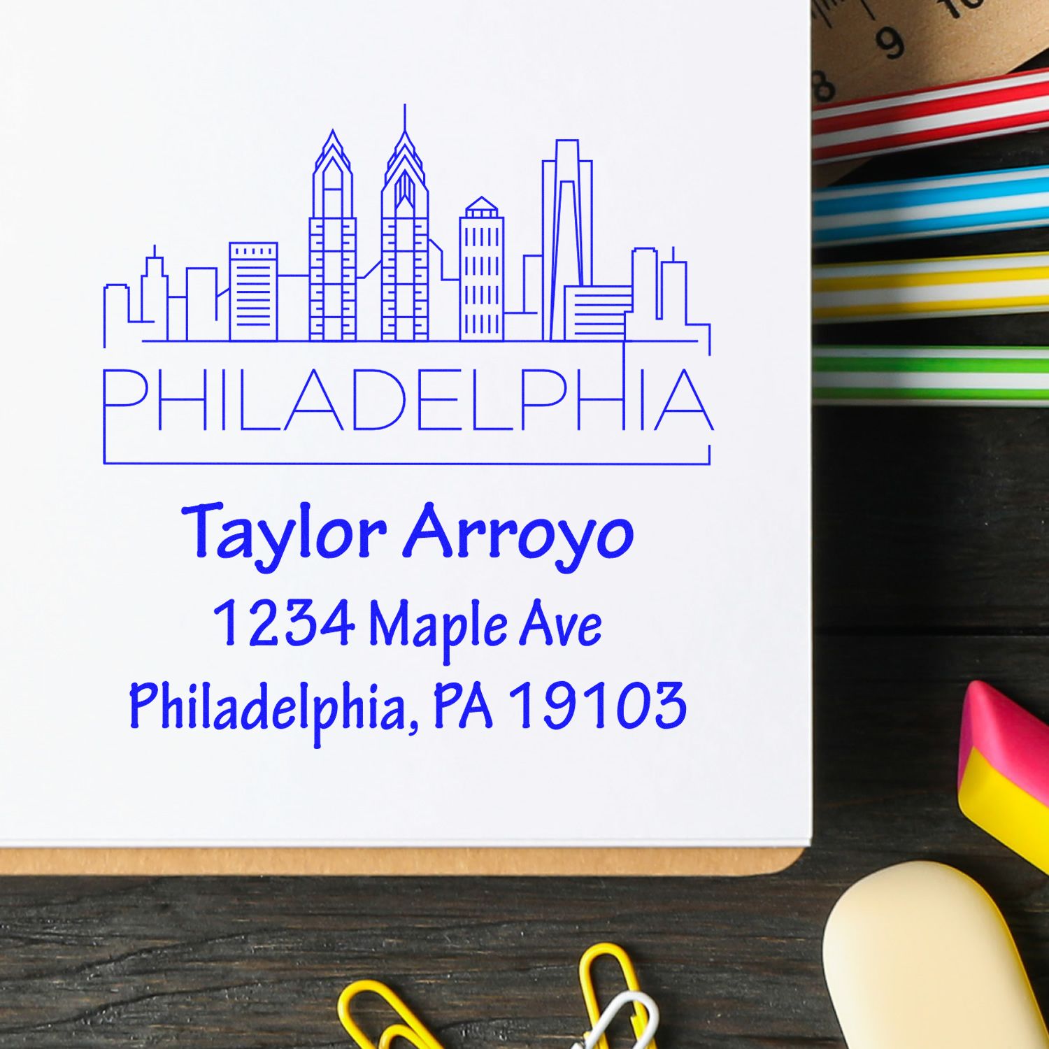 Custom Philadelphia address rubber stamp with skyline design for Taylor Arroyo, 1234 Maple Ave, Philadelphia, PA 19103.