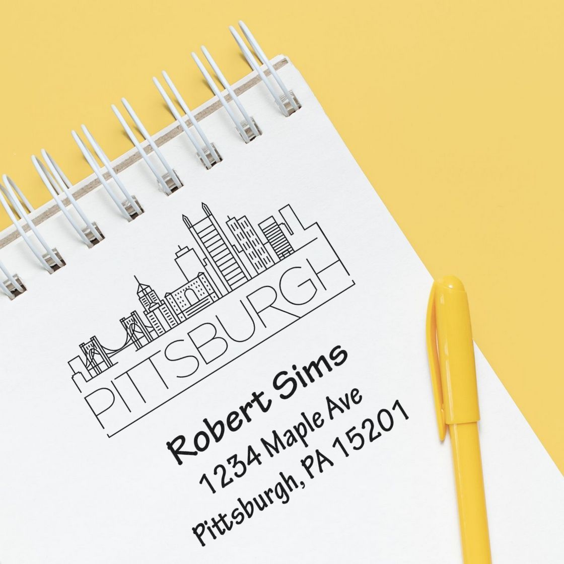 Custom Pittsburgh skyline rubber address stamp on notebook with personalized name and address for stationery branding