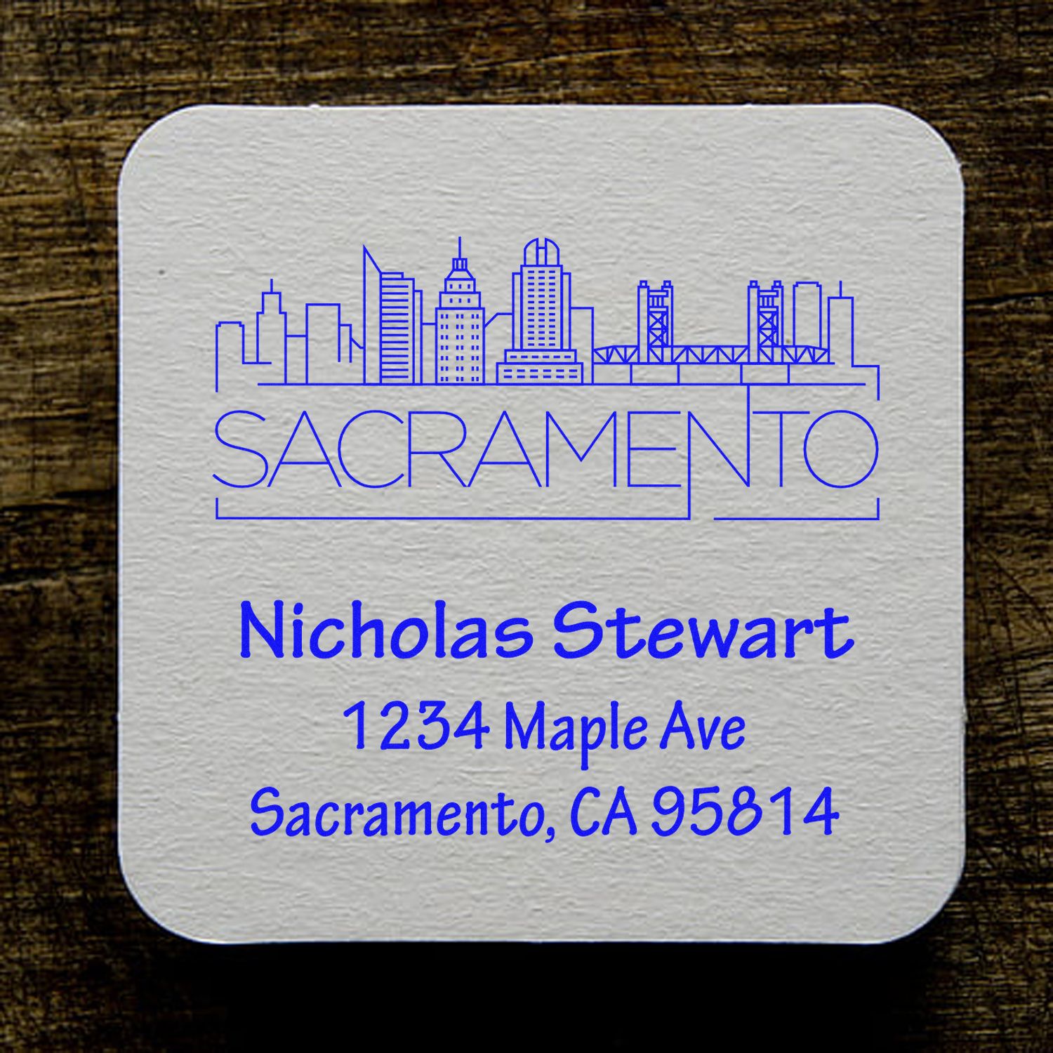 Custom Sacramento return address rubber stamp design with skyline, Nicholas Stewart, and 1234 Maple Ave, CA 95814.