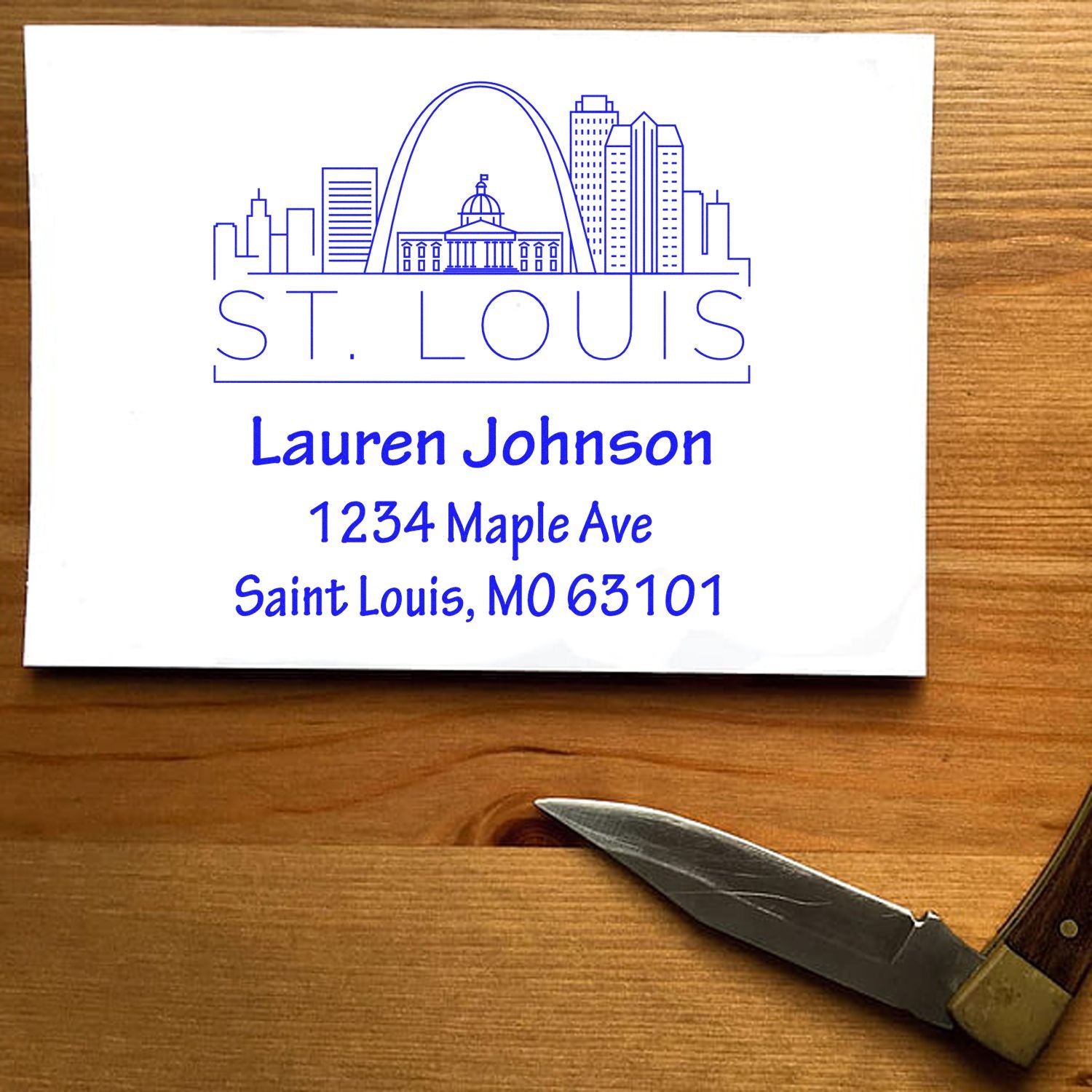 Custom St. Louis return address rubber stamp with skyline, Lauren Johnson, 1234 Maple Ave, Saint Louis, MO 63101.