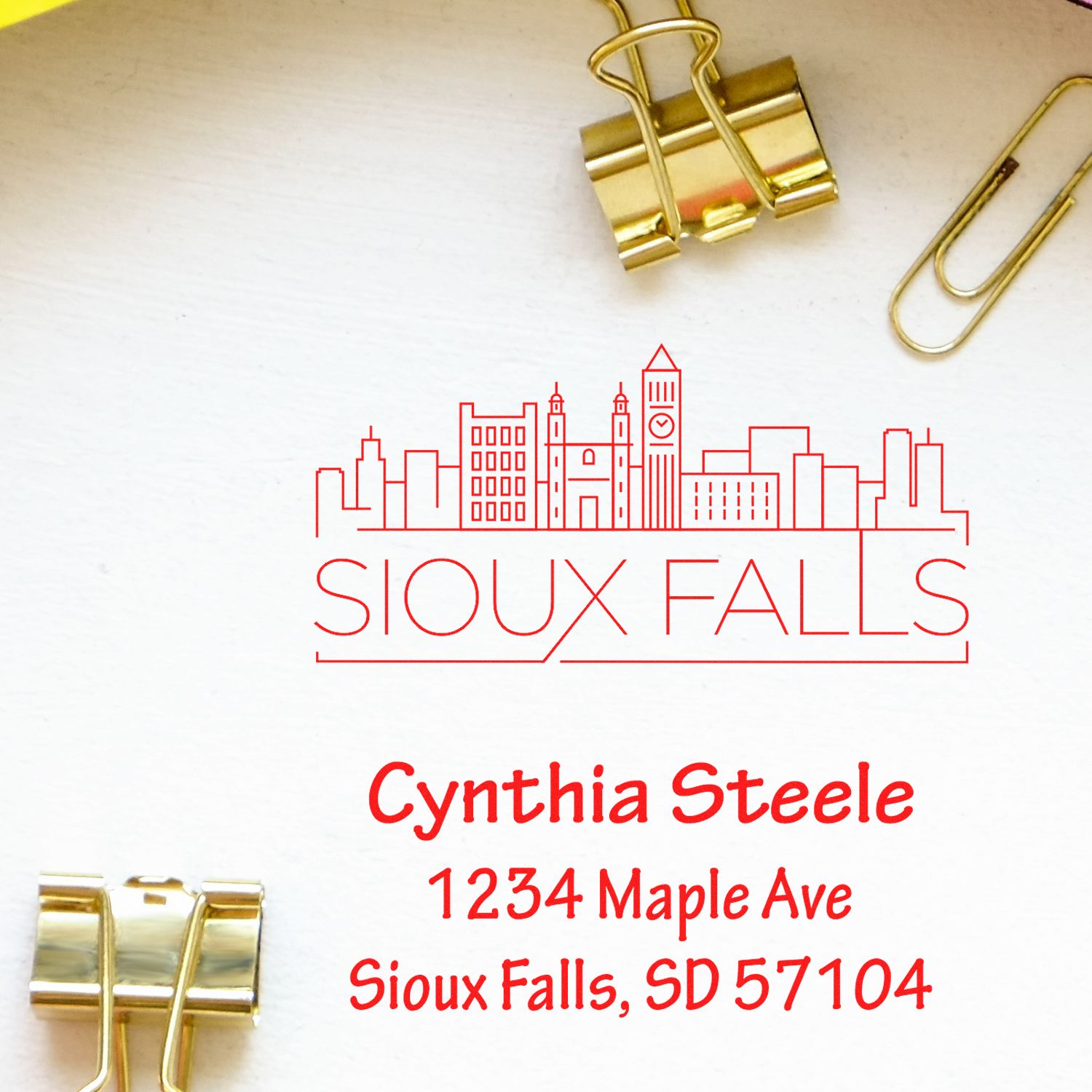 Custom rubber address stamp with Sioux Falls skyline and Cynthia Steele return address for mailing, branding, and labeling.