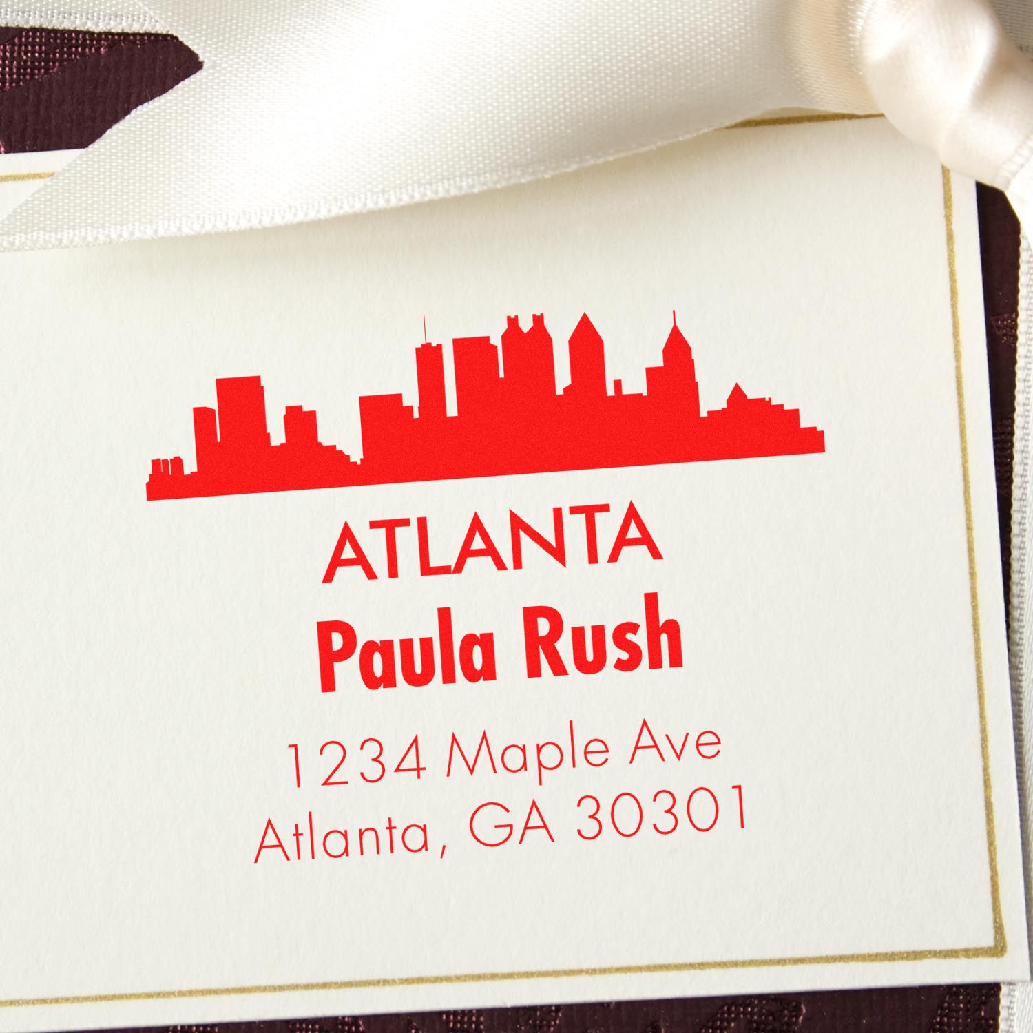 Custom Atlanta skyline return address rubber stamp with personalized name and address in red.