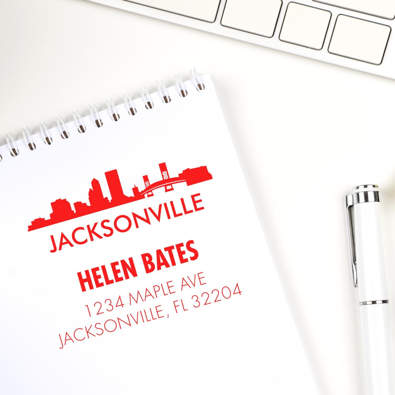 Personalized rubber address stamp for Helen Bates, featuring Jacksonville skyline and Maple Ave address.